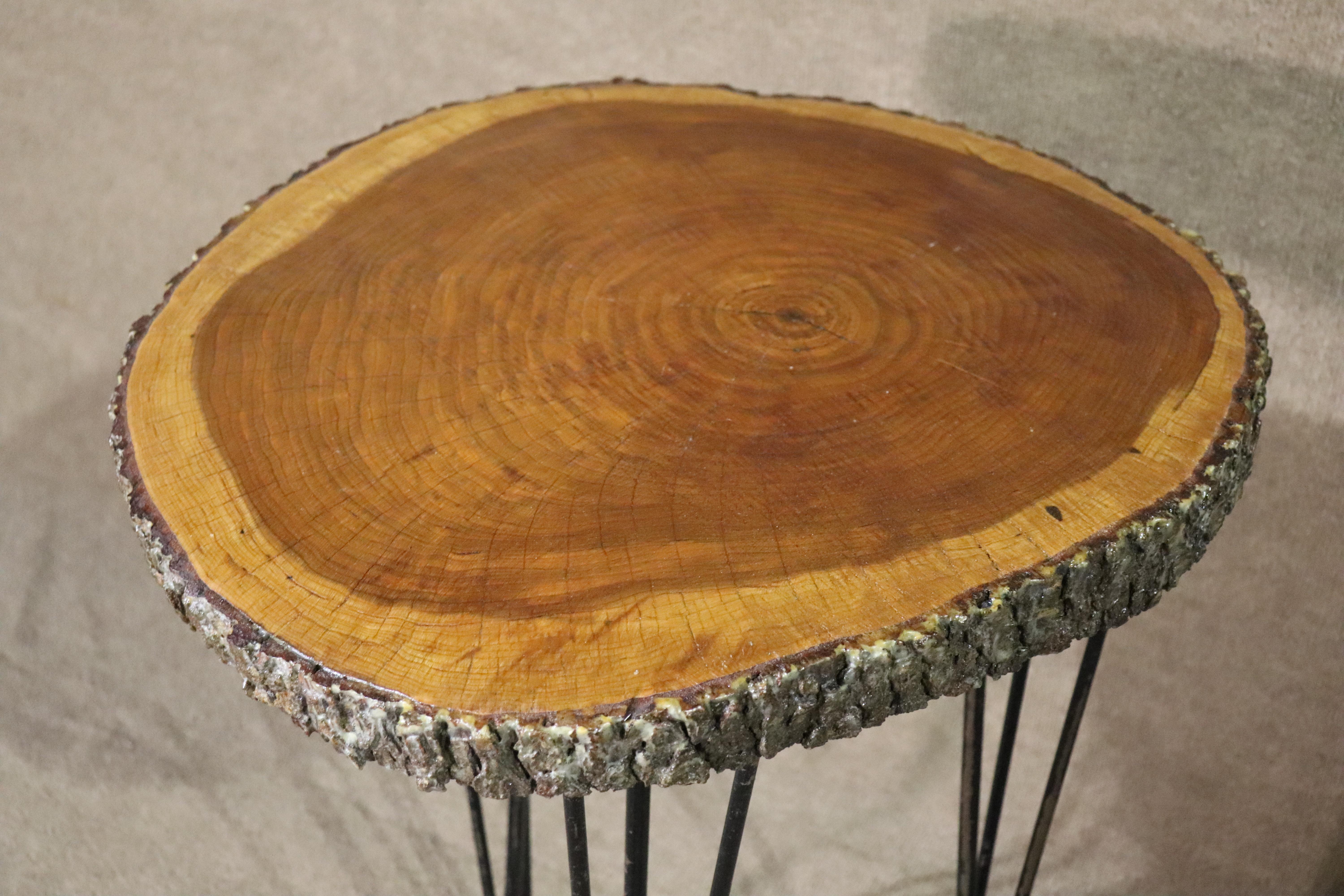 Studio made side table or pedestal with a wood slab on hairpin iron legs. Table top has an attractive rustic style with exposed live edge.
Please confirm location NY or NJ