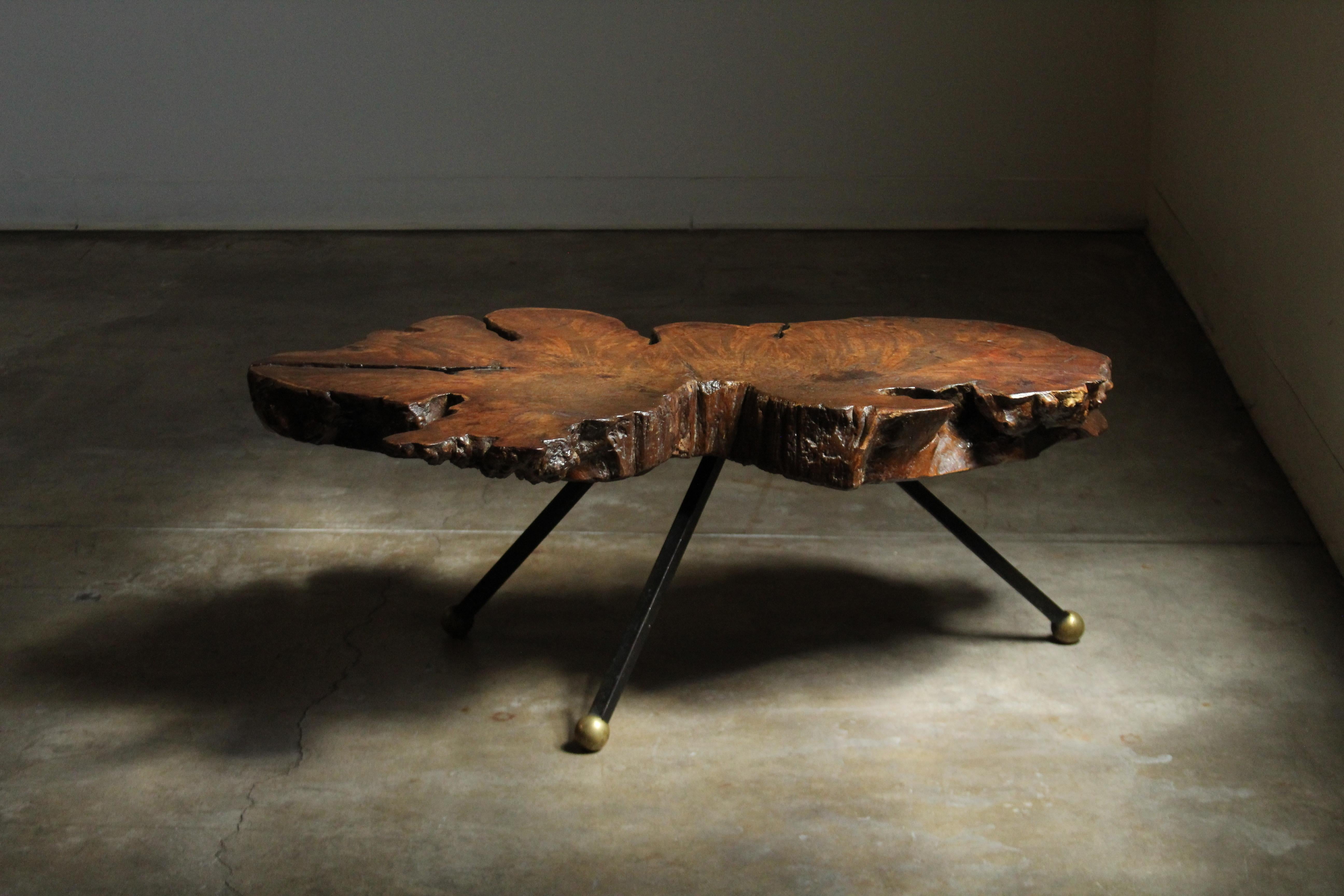 An incredible freeform, live edge coffee table by Sabena of Mexico, produced in Mexico in the 1960s. This small scale, heavy duty coffee table features a solid 4
