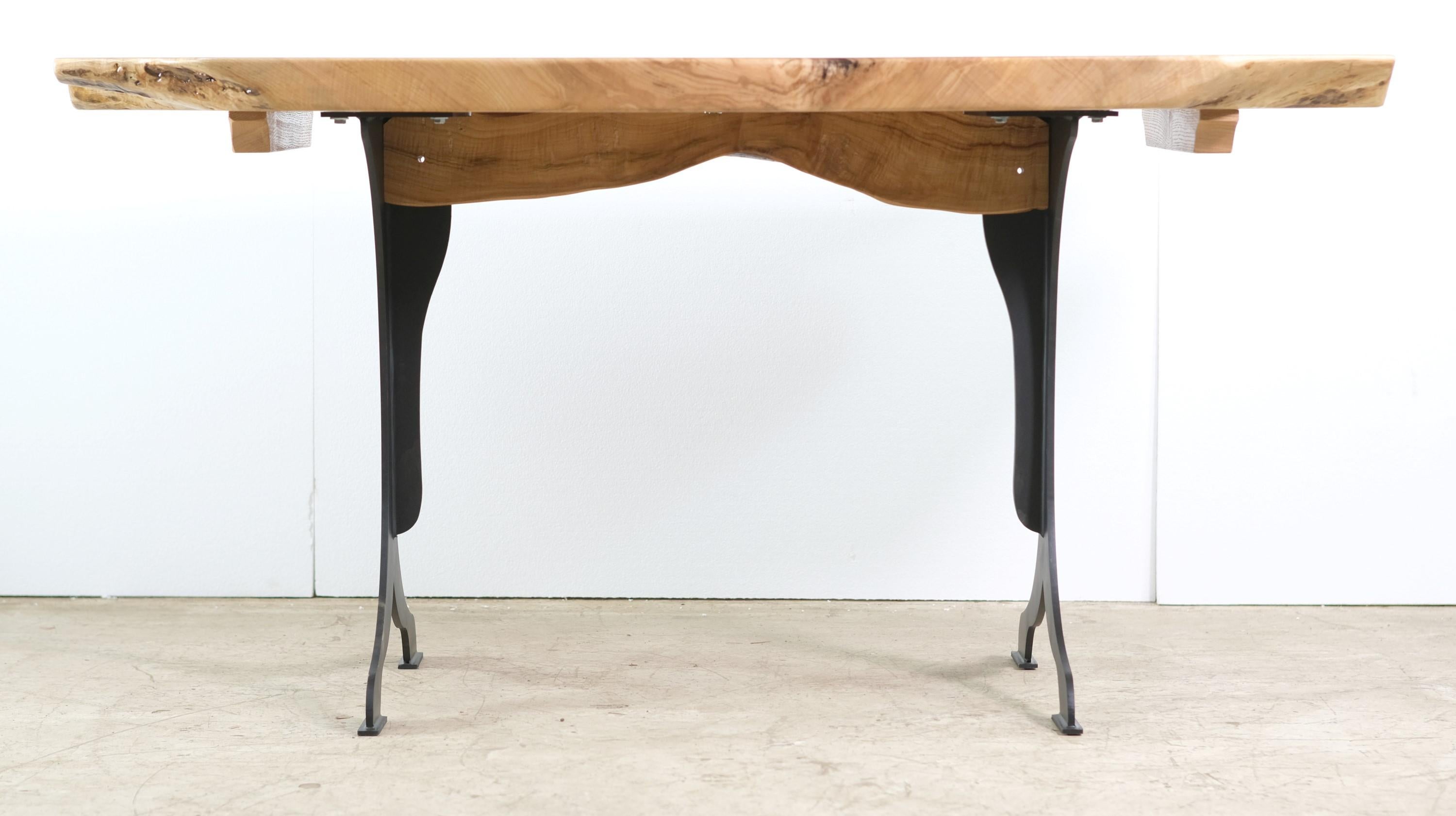 This table top is made from a single slab of solid maple in a live edge Modern style. Clear resin accents. Laser cut and blackened wishbone steel legs. Please note, this item is located in one of our NYC locations.