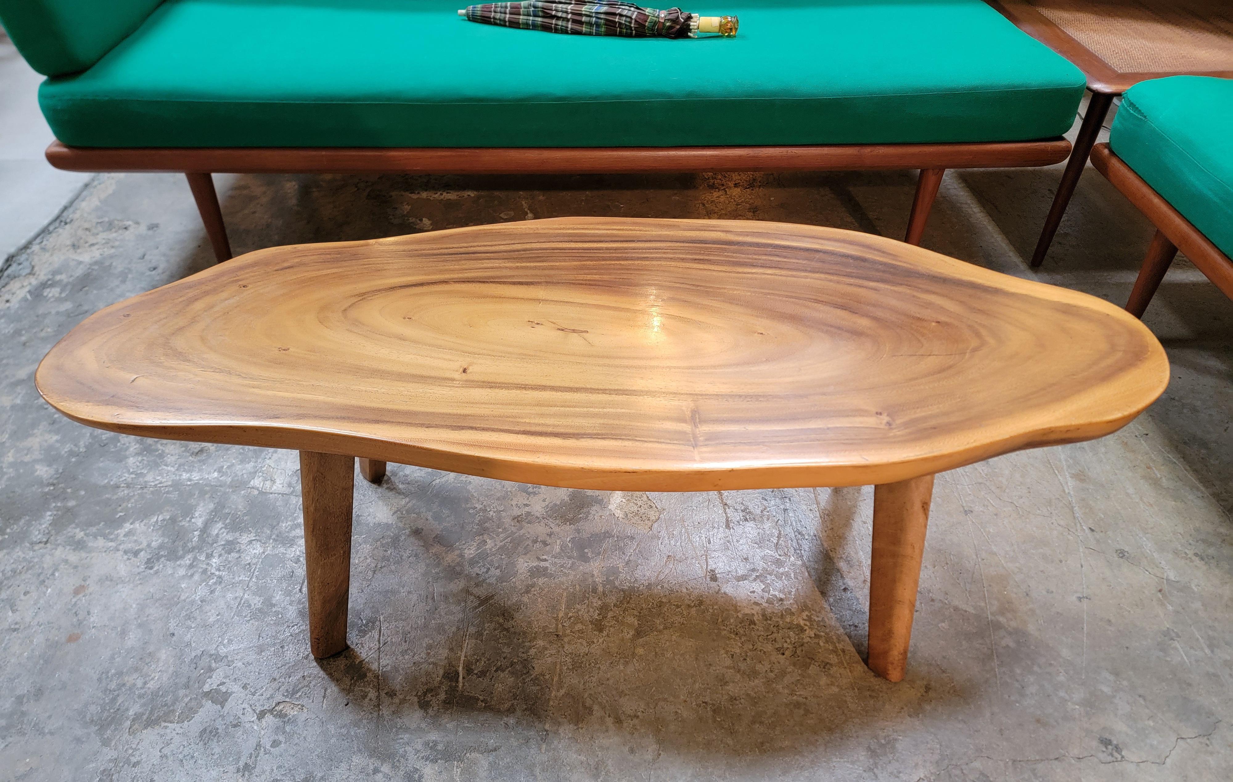 Solid slab organic modern coffee table. South Pacific ion origin. Exceptional wood grain top top of slab. Legs made of same material as top. very nice original condition. Circa. 1950's. Measures 48.5 inches wide.