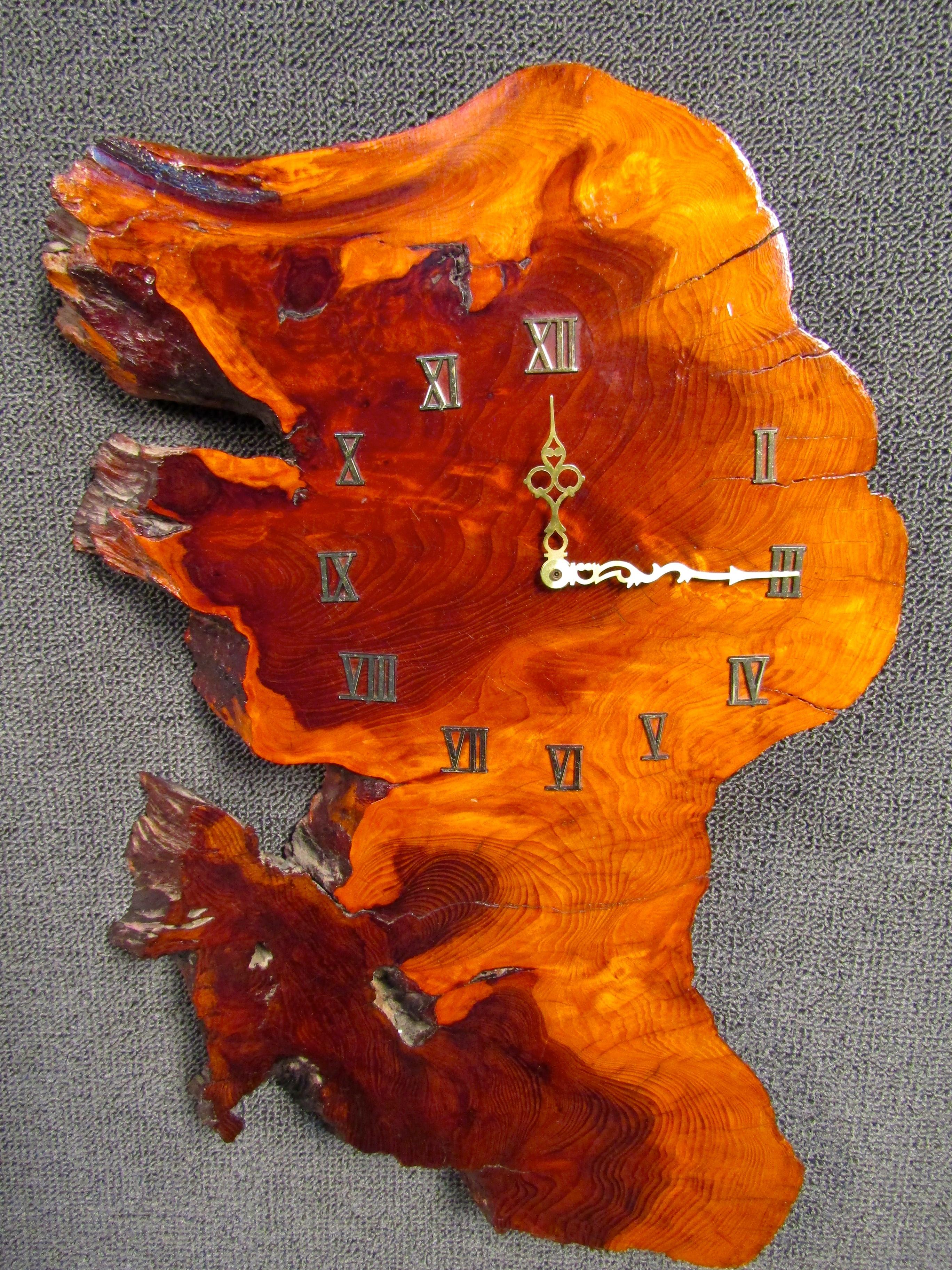 Unique lacquered wood slab roman numeral clock. This beautiful piece of wood features a rich vibrant grain pattern, roman numeral lettering and ornate gold clock hands.

(Please confirm item location - NY or NJ - with dealer).
 