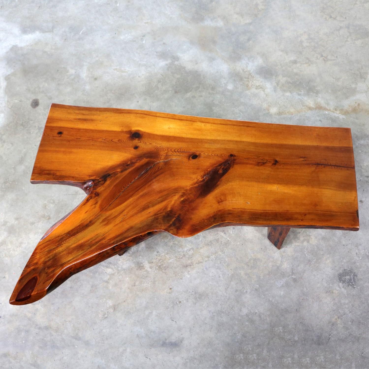 Incredible midcentury live edge or free edge solid slab coffee table or bench in the style of George Nakashima. It is in wonderful vintage condition with normal wear, circa 1950s-1980s.

Organic modern is always in style. And this coffee table, or