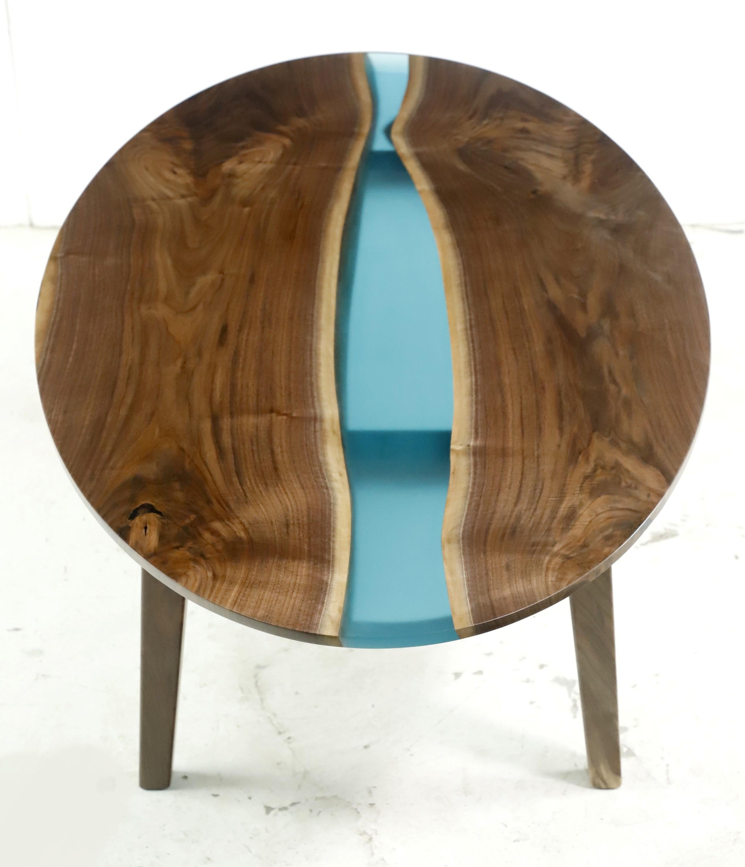 Newly made from recovered walnut, this table features a two slab solid walnut construction with a blue center resin pour. Comes with Modern style tapered legs. Please note, this item is located in one of our NYC locations.