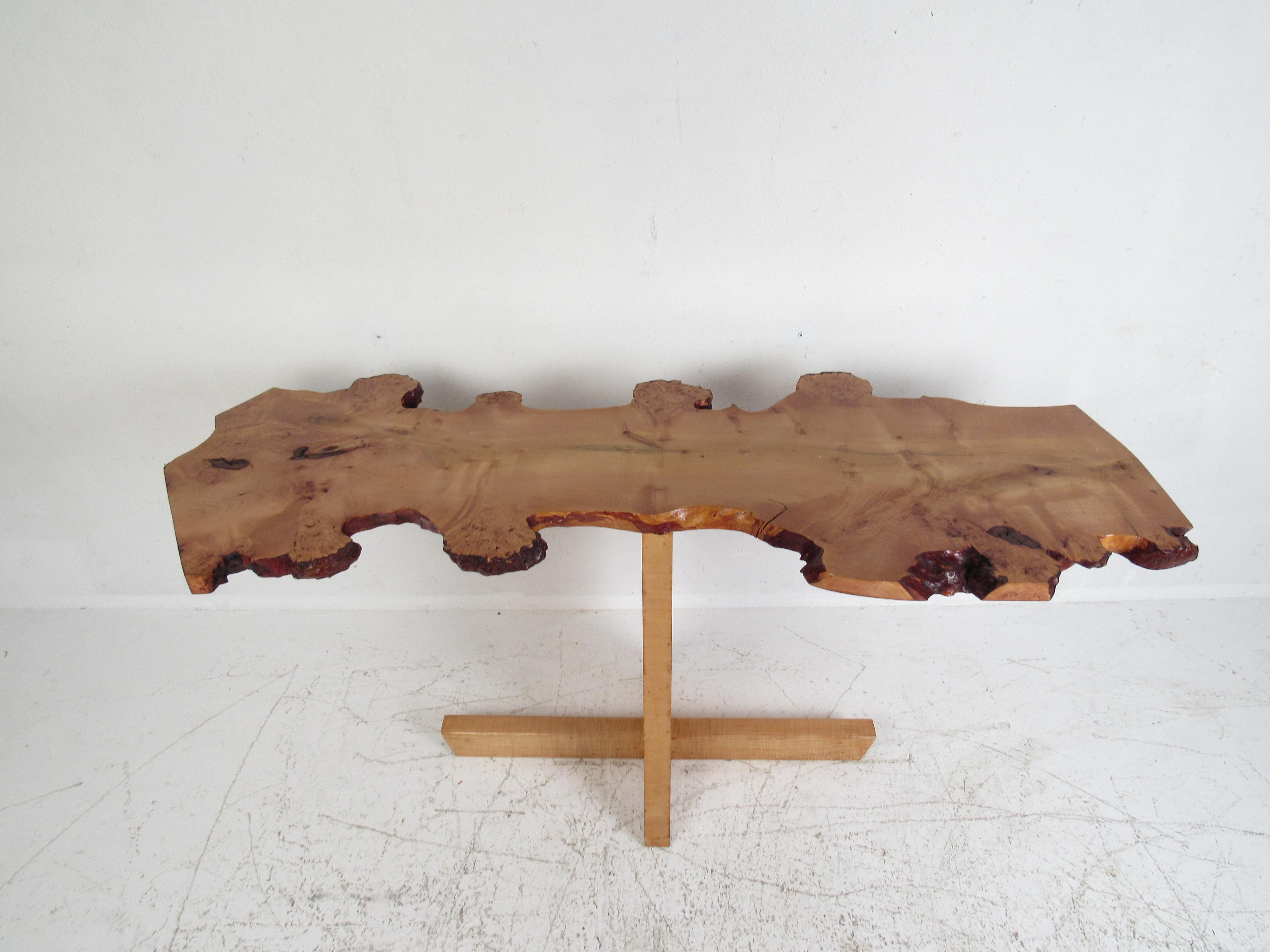 This stunning contemporary modern hall table features a live edge tree slab top and a burlwood base. An unusual design that looks great behind the sofa, in the entryway, or in the hallway. This custom made table makes the perfect addition to any