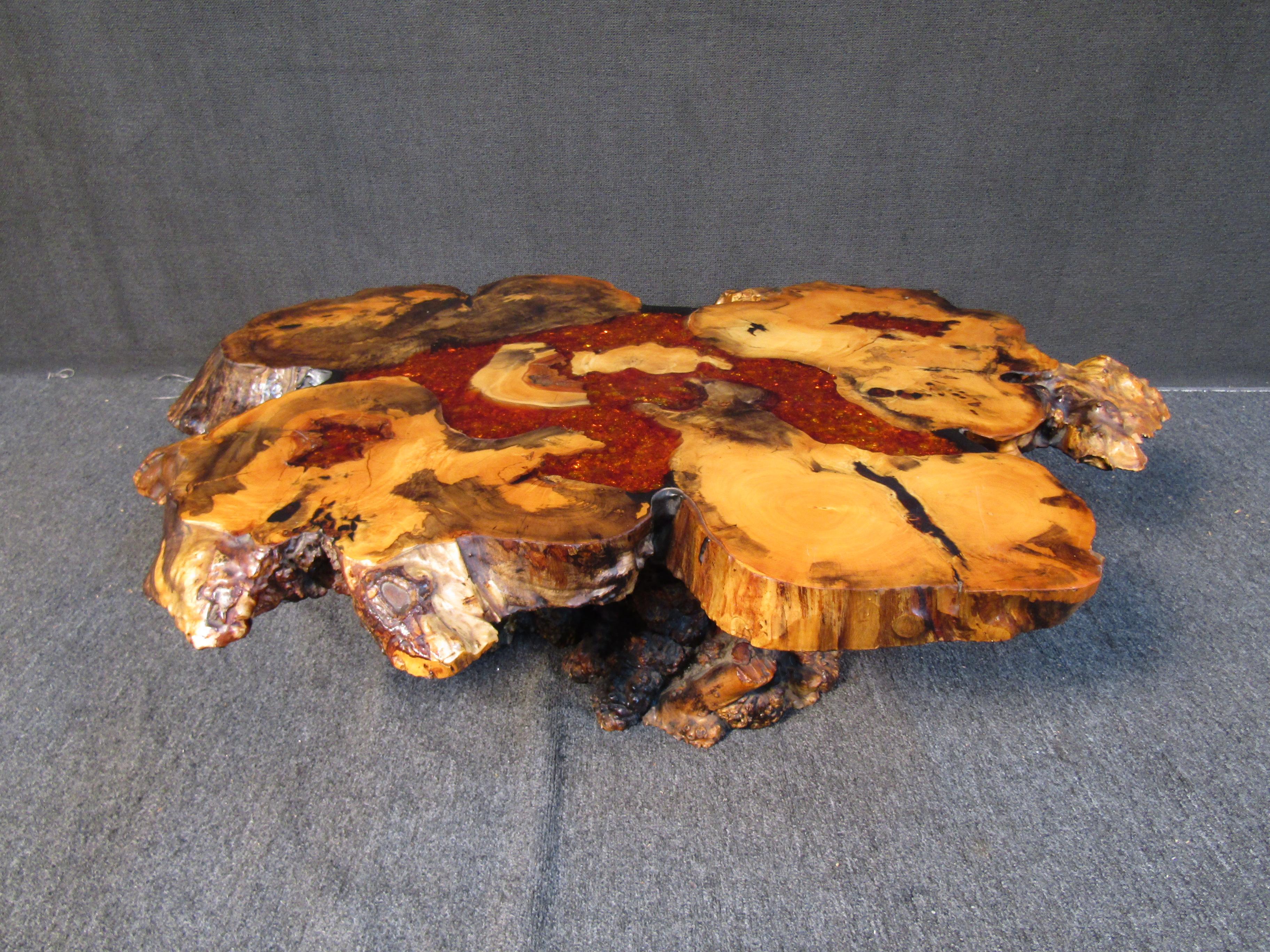 Beautifully figured live edge wood stump coffee table with a shining garnet colored resin filler. Please confirm item location with seller (NY/NJ).