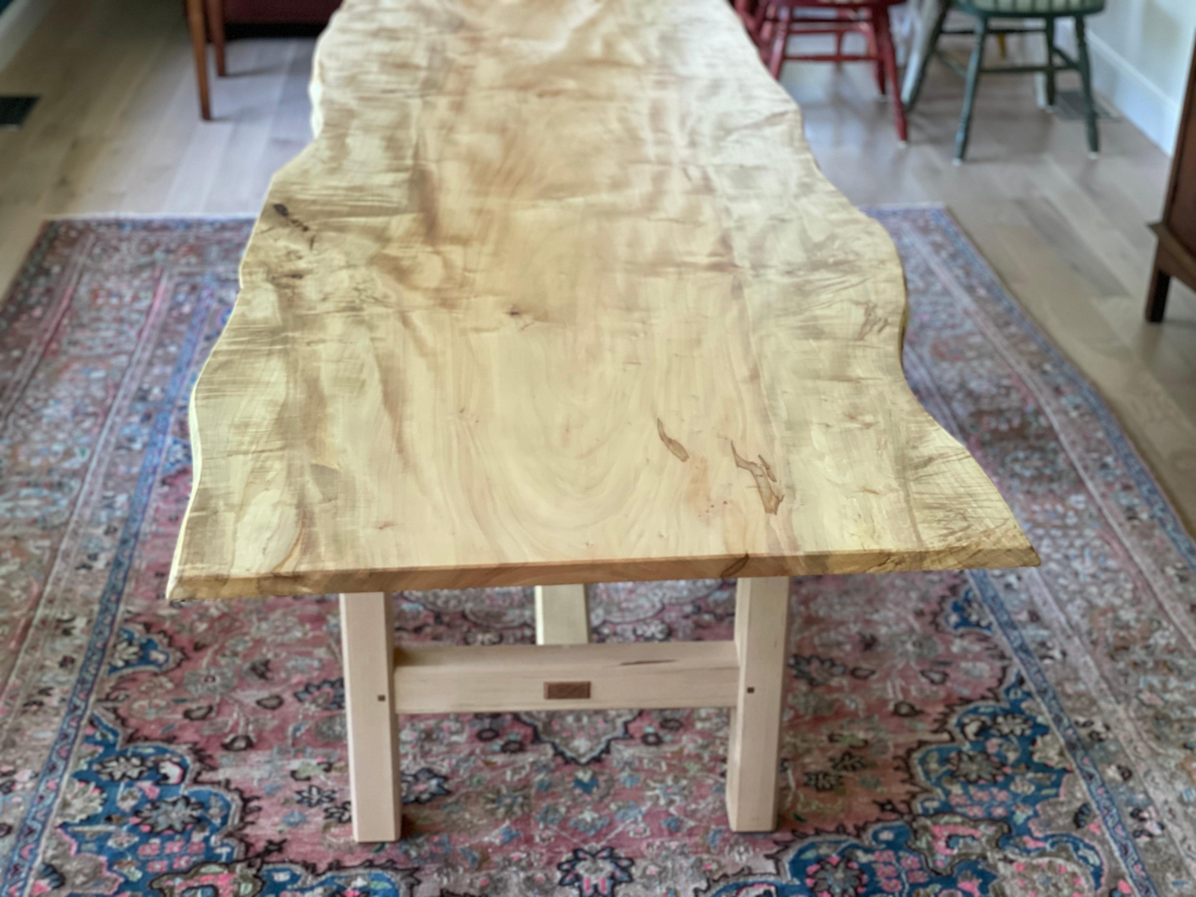 Cette table à manger à tréteaux, fabriquée à la main, présente des éléments propres à la charpente traditionnelle japonaise, ce qui en fait une table à manger subtile et très solide. Cette table comporte une lourde dalle de frêne blanc scié sur
