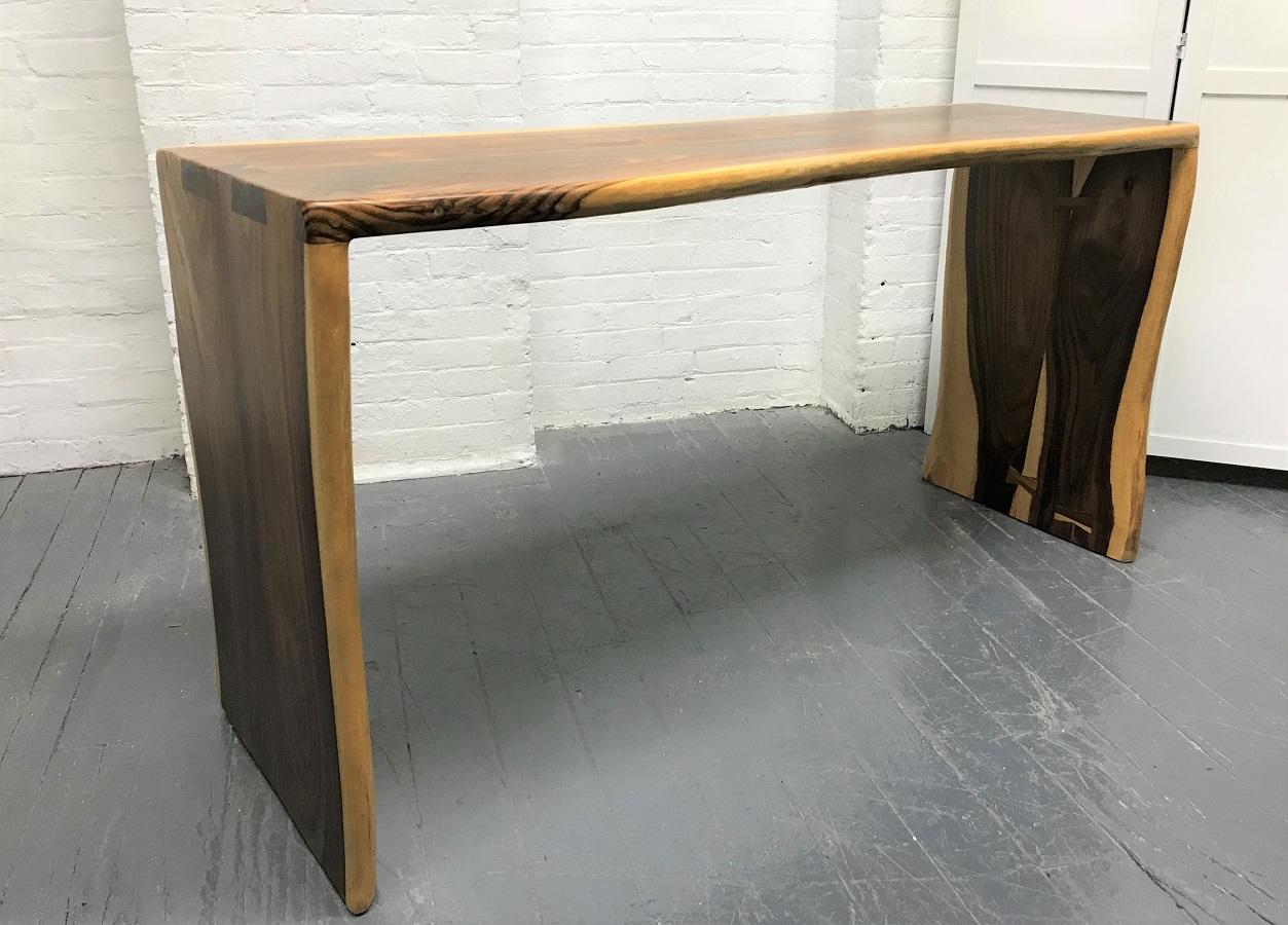 Live edge solid walnut console table. The console is well made with dove-tail joinery to the top and sides.