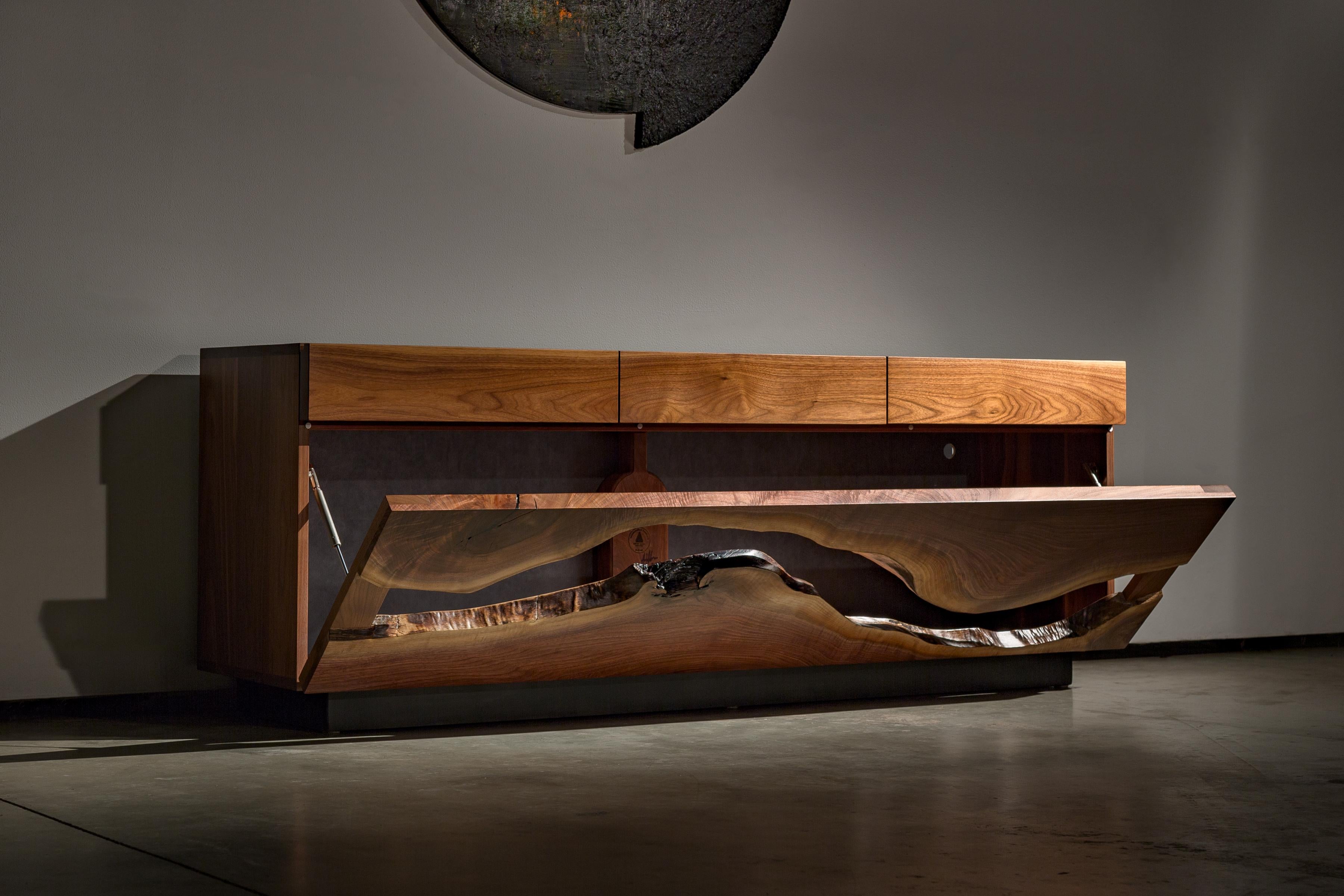 Made from solid walnut and a blackened steel base, the St. Clair Credenza shows off the natural beauty of the live edge walnut with sleek lines and elegance. While still functional, this piece will stand out in any room and fit many styles.

This