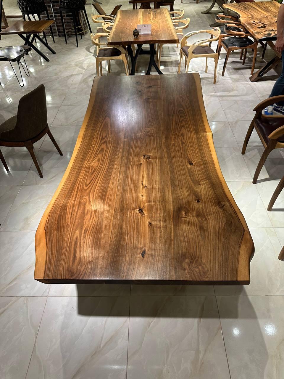 Custom Walnut Wood  Live Edge Epoxy Resin Dining Room Table 

This table is made of Walnut Wood. The grains and texture of the wood describe what a natural walnut woods looks like.
It can be used as a dining table or as a conference table. Suitable