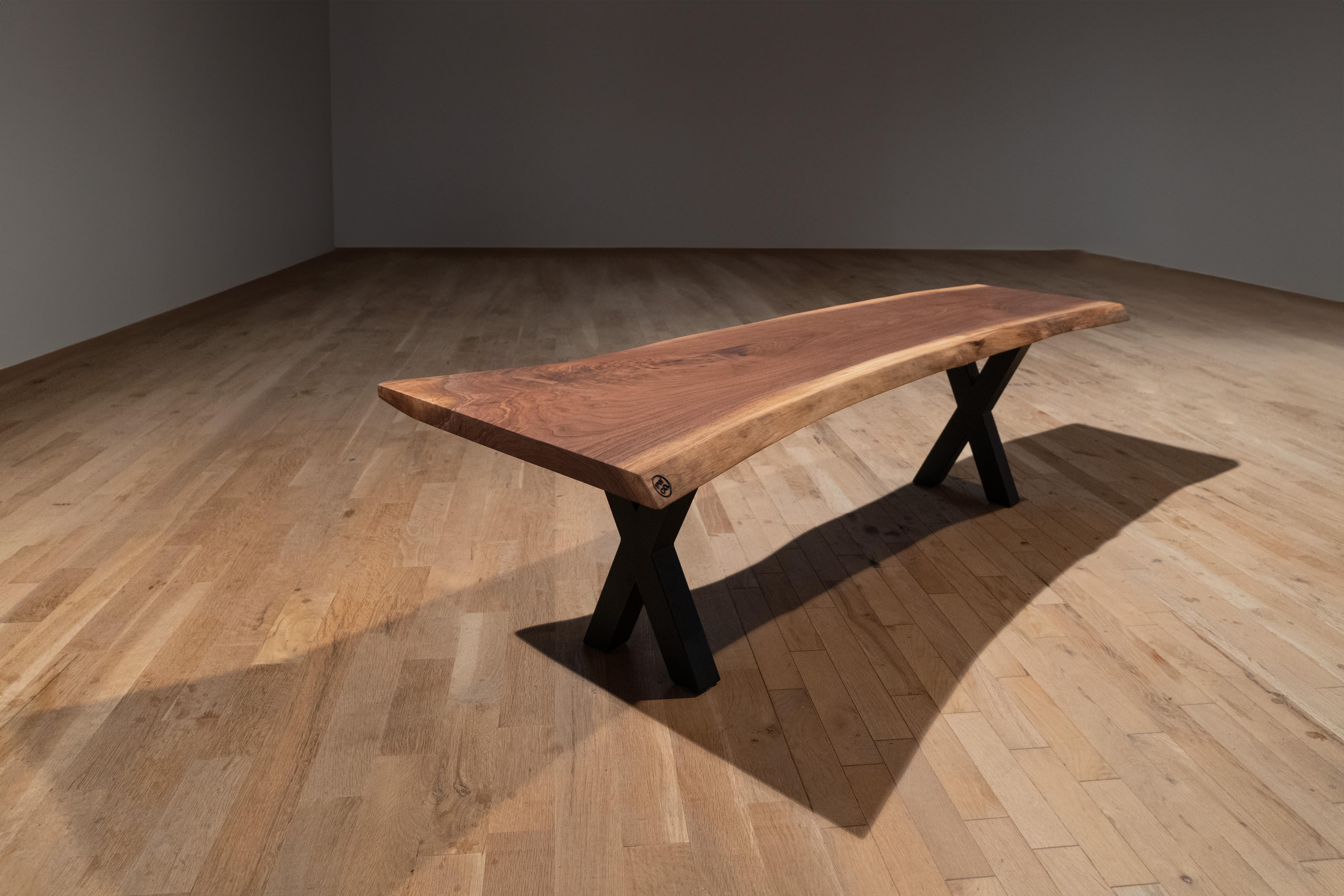 This bench is a single slab of walnut supported by a modern X-base. Whether placed in a sleek loft or a minimalist office, its fusion of natural elements and contemporary aesthetics adds an inviting touch of sophistication to any space.

A Paramount
