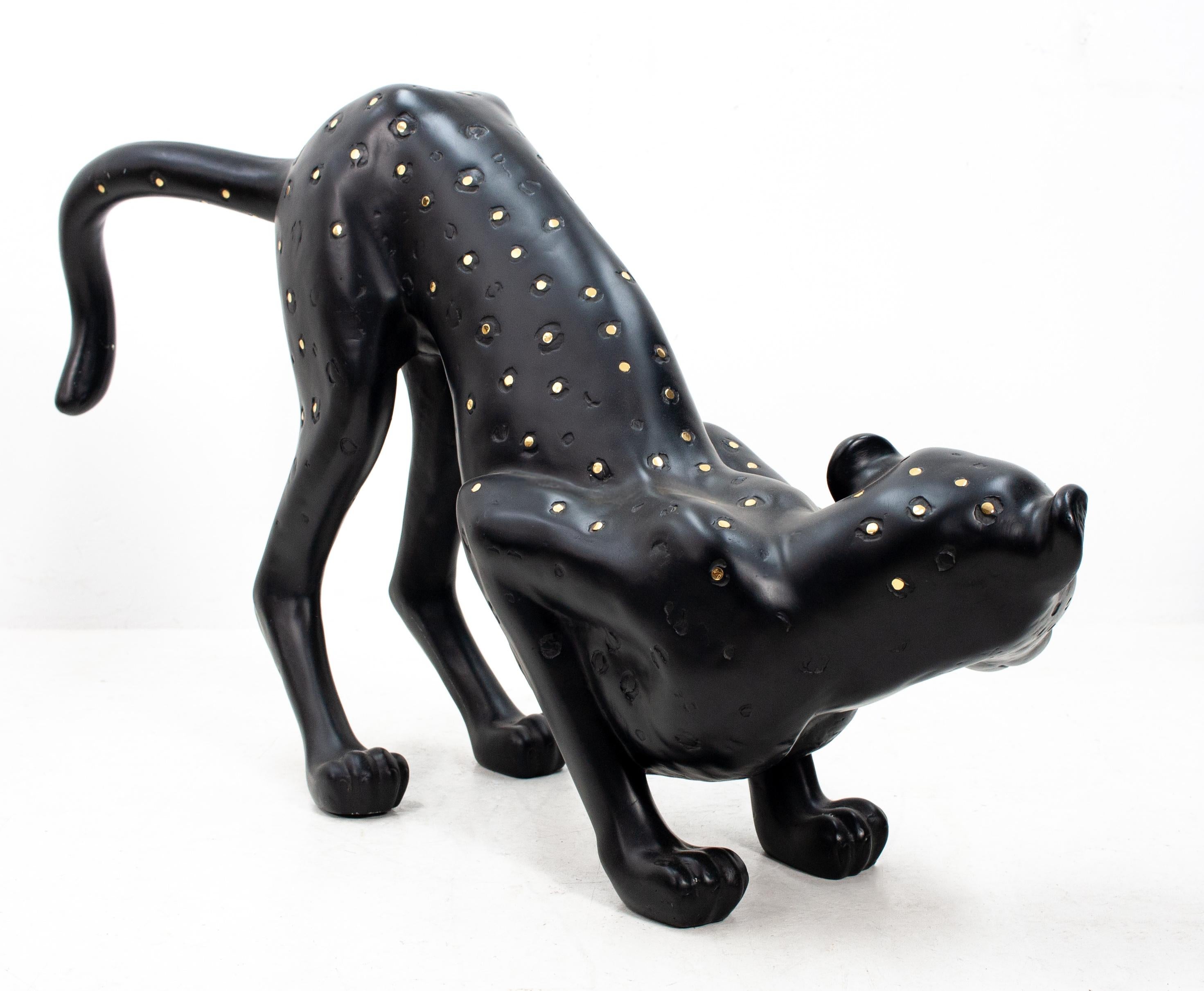 Large resin cheetah, black with brass dots. Very decorative animal, 1980s. Ready to attack.
Hollywood Regency style.
        