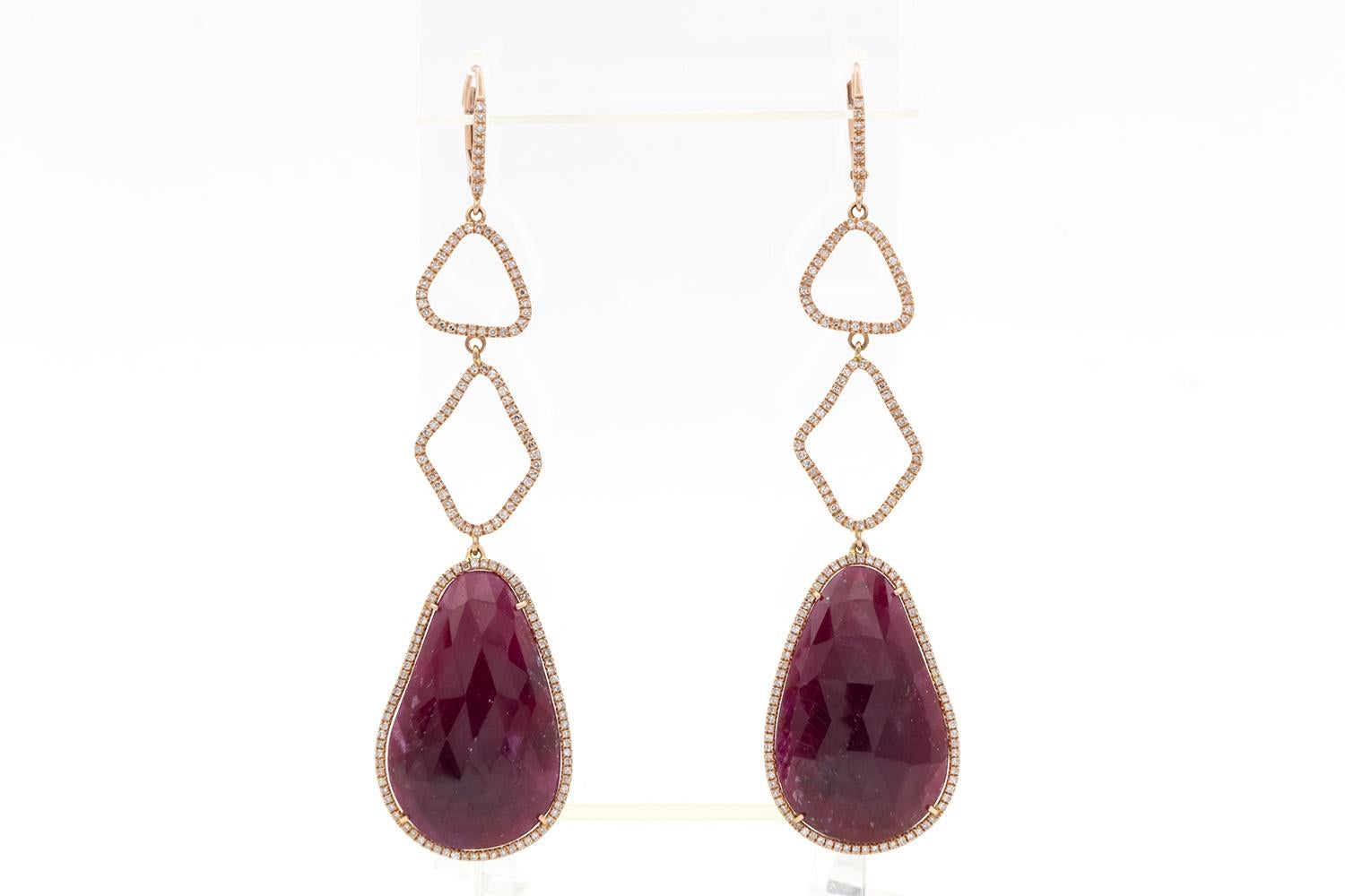 We are pleased to offer these Brand New Unworn Liven 14k Rose Gold Ruby & Diamond Dangle Drop Earrings. These stunning earrings are fun and vibrant! They feature 51.55ctw natural rose cut rubies accented by 0.85ctw round brilliant cut diamonds set