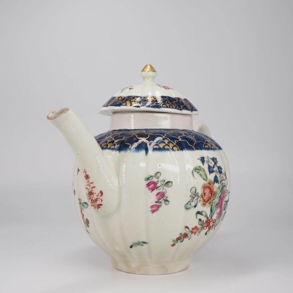 Rare Liverpool teapot, by Philip Christian & Co., the fluted body boldly painted with flower sprays beneath a broad collar of underglaze blue with gold highlights forming a ‘Cracked Ice’ pattern, the lid with similar decoration around an angular