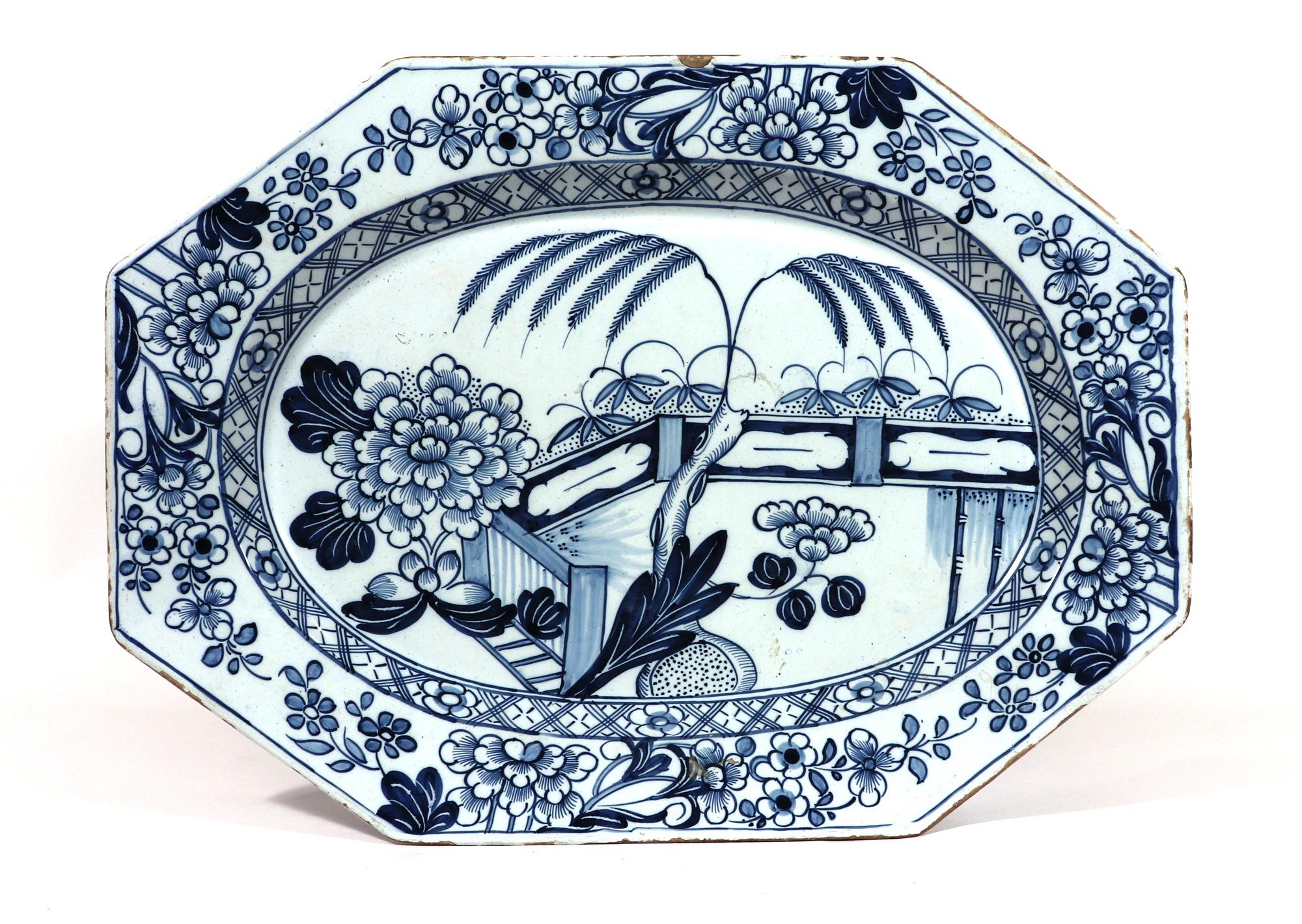 Delftware Blue & White Chinoiserie dish,
Irish (Dublin) or Liverpool,
1745-65

The rectangular British Delftware underglaze Blue Dish with canted corners and of large size is painted with a Chinoiserie garden scenes. The central well with a