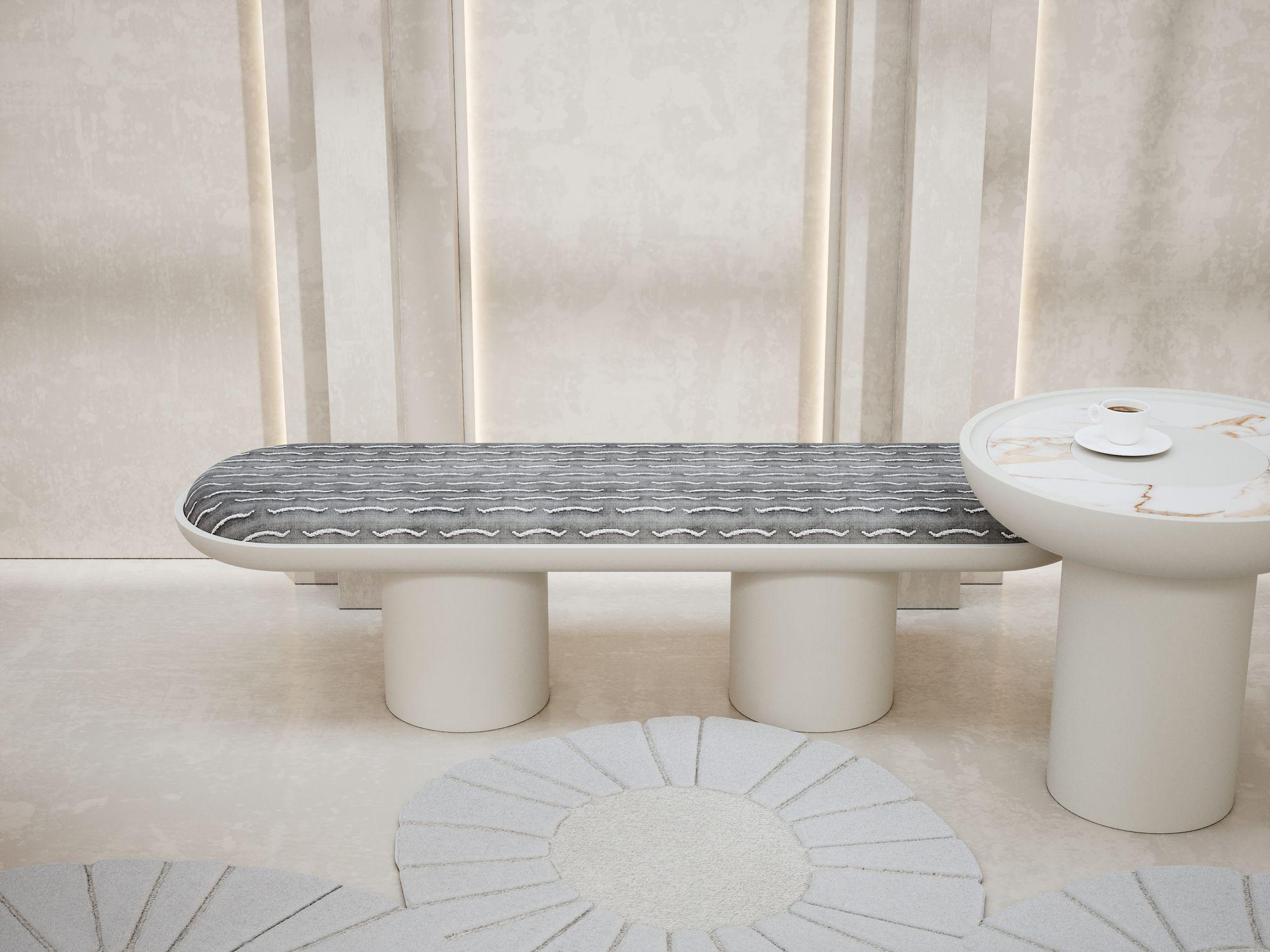LIVIA bench presented in Dedar fabric upholstery, Nouvelles Vagues 002, velvet featuring jacquard workmanship, an admired tribute to the appearance and tactile sensations of a tiger coat.
The upholstery is immersed in a rounded shape, painted in a