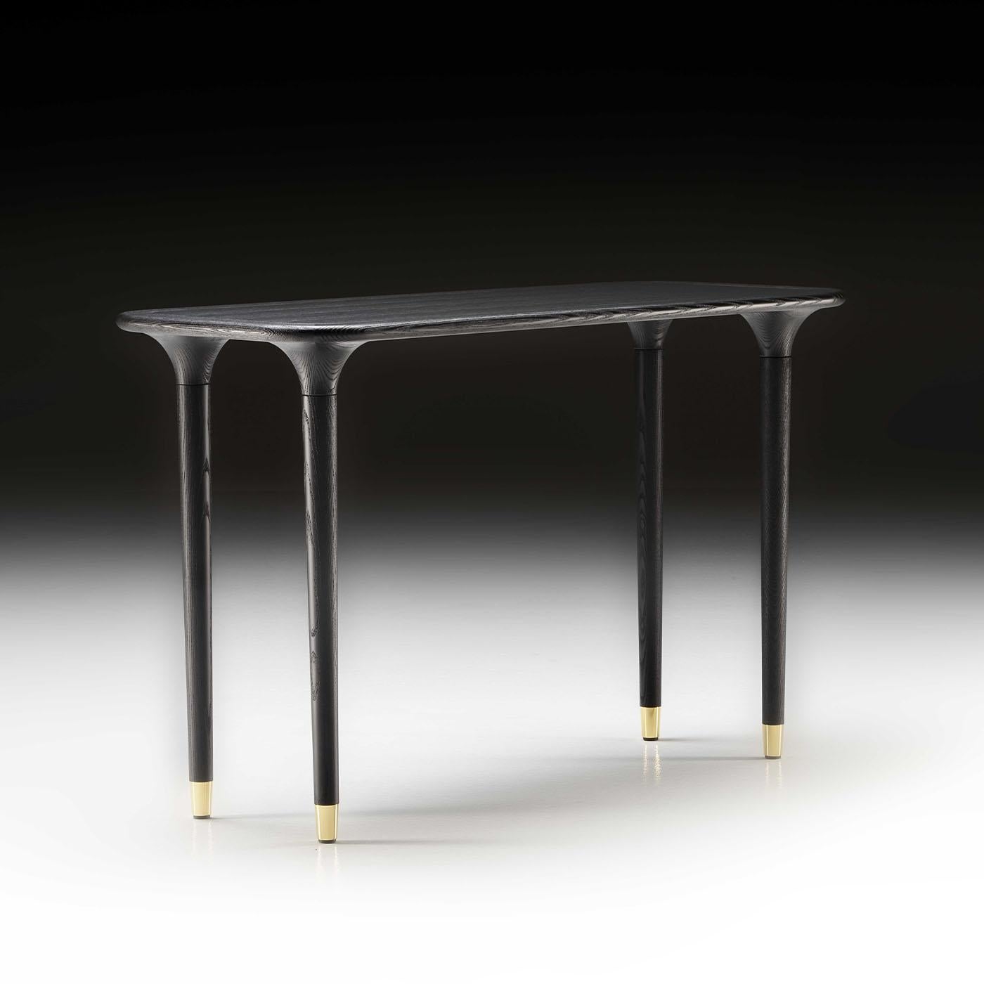 Thoughtfully balanced proportions combined to smooth curves define the elegant look of this console in solid mocha-stained ash. Illuminated by the presence of galvanized golden tips, the tapered legs meet the top by following a progressively flaring