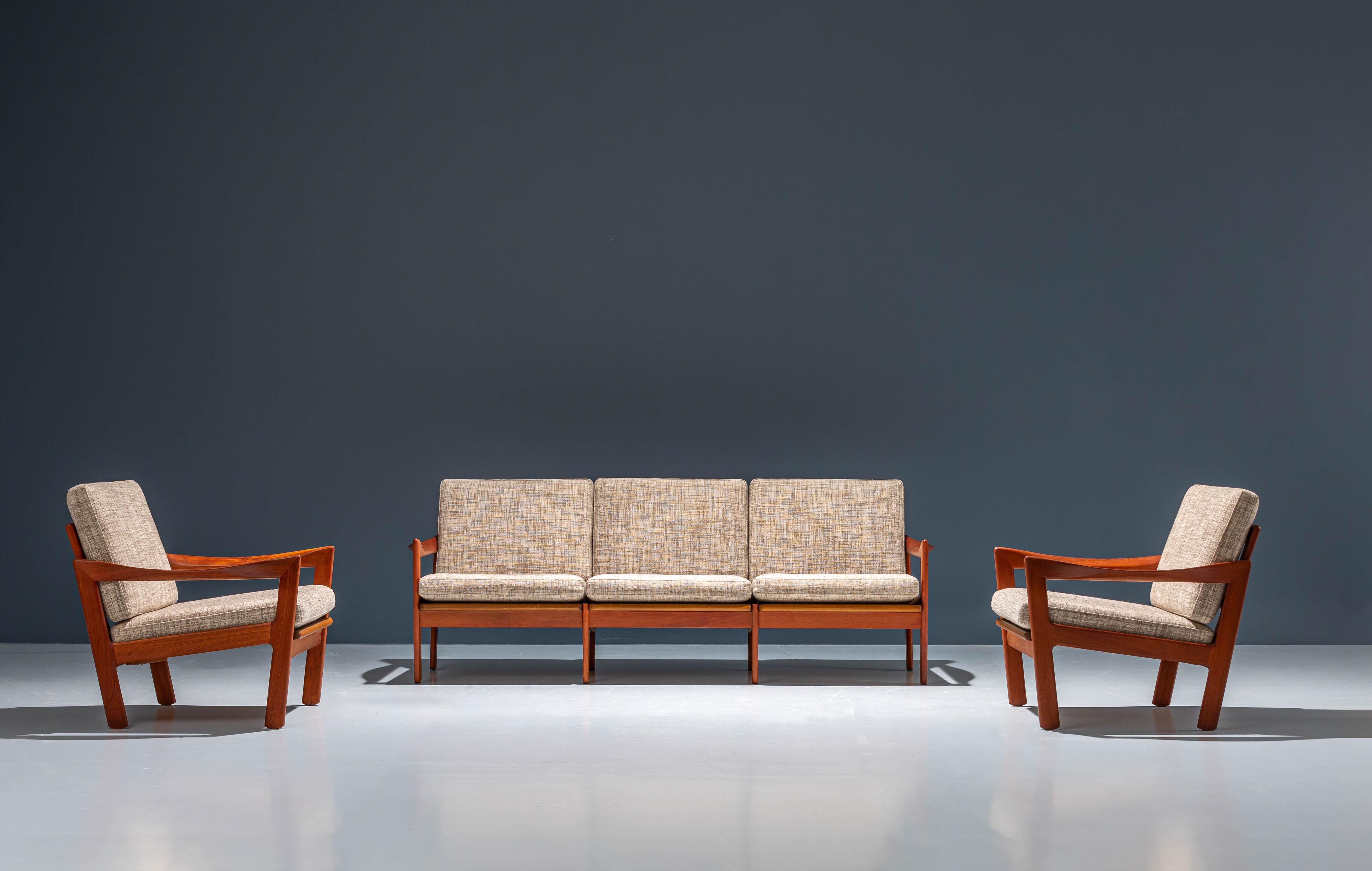 Set of two Loungechairs and one 3-seat Sofa by Illum Wikkelsø for Niels Eilersen in teak and fabric. The fabric is still in very good condition, clean and crisp and the teakwood is very shiny and vibrant. A luxurious living room set full of