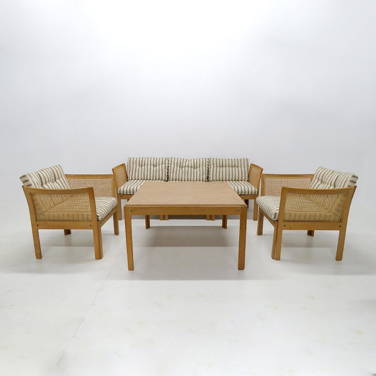 Wonderful living room set designed by Illum Wikkelsø for C.F. Christensen, Silkeborg, in Denmark, 1960, consisting of two armchairs, a three-seater sofa (with additional possible configurations) and a coffee table with oak frames, and back and sides
