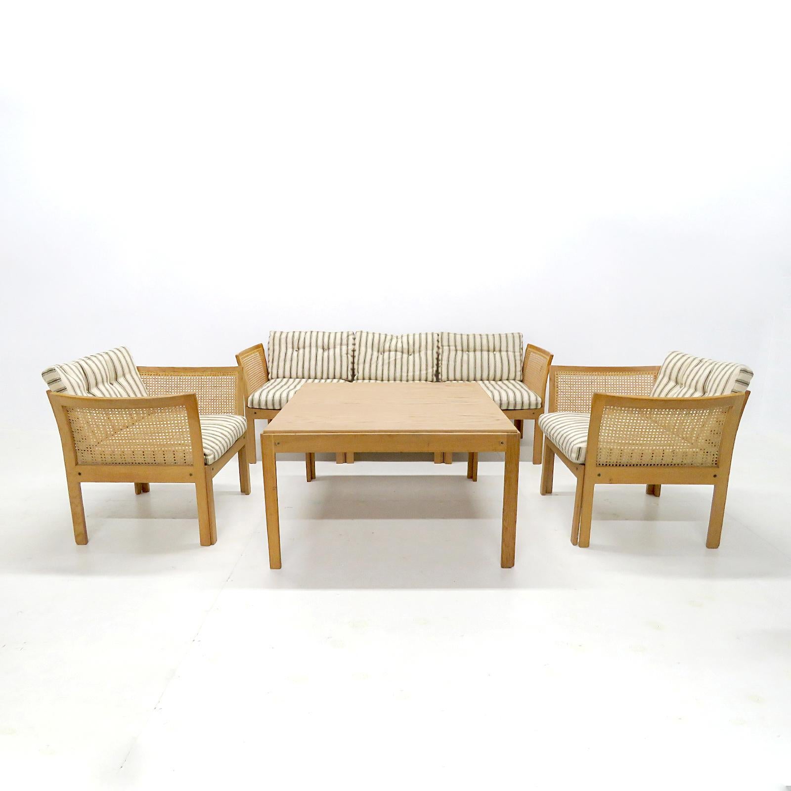 Wonderful living room set designed by Illum Wikkelsø for C.F. Christensen, Silkeborg, in Denmark, 1960, consisting of two armchairs, a three-seater sofa (with additional possible configurations) and a coffee table with oak frames, and back and sides
