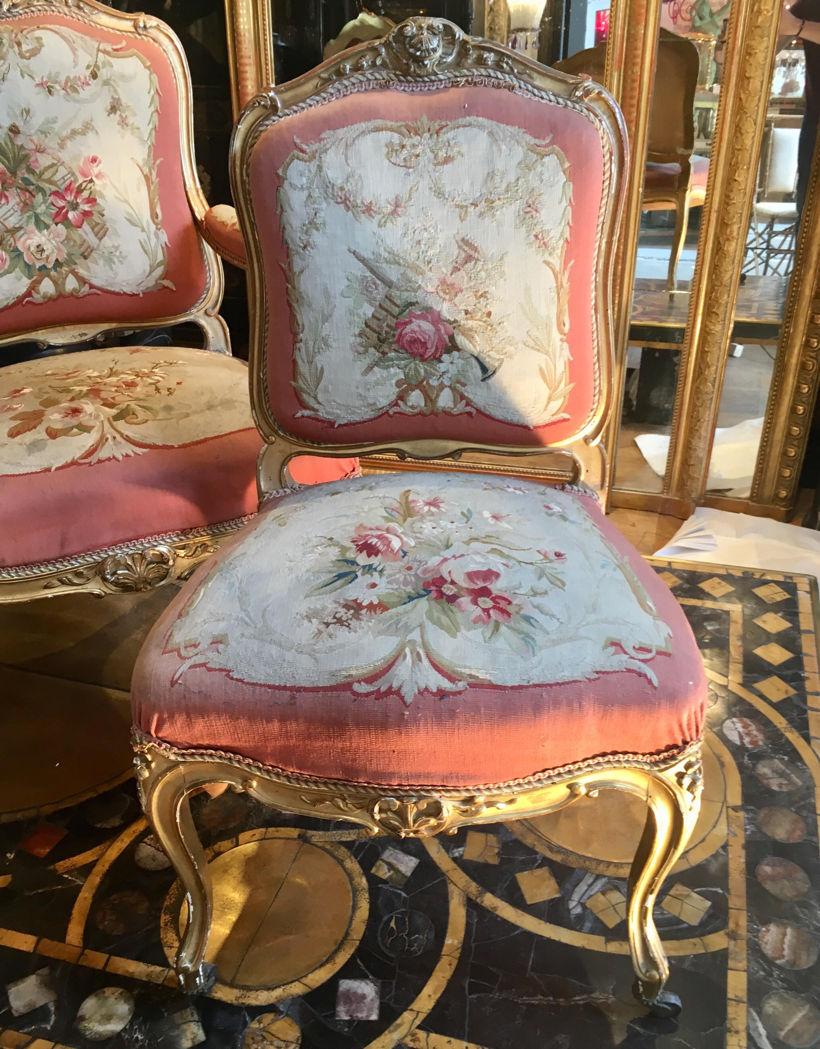 Beautiful living room set with two chairs and two armchairs, 19th century, circa 1860, Napoleon III style in Aubusson tapestry on the theme of music.
Flowers, music instruments, etc.
Very fresh color coral.
Carved and gilded wood.
Two wheels on