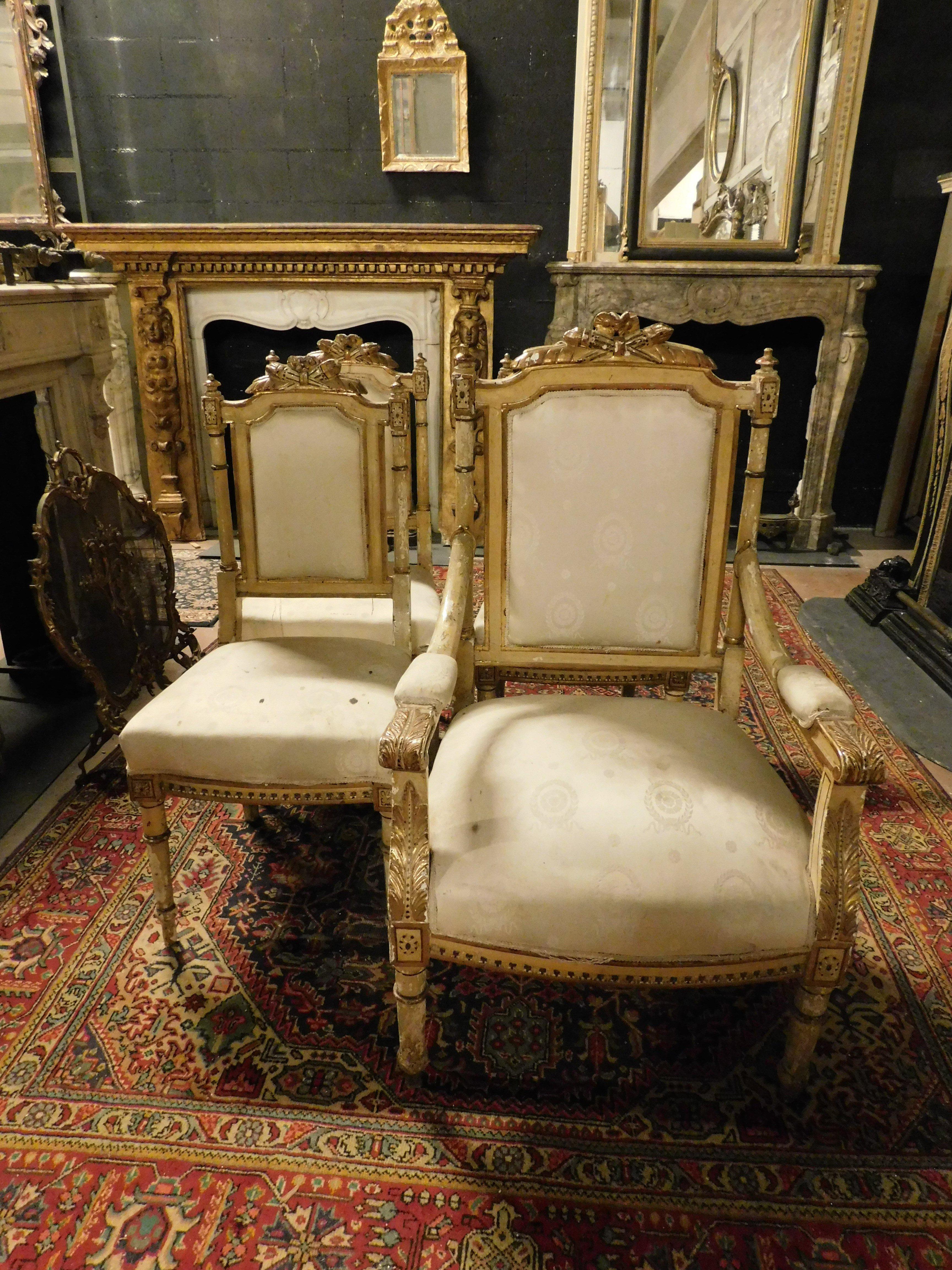 Antique living room set composed of 1 armchair and 3 chairs, richly carved and gilded, Louis XVI, from an important hall of a noble house in northern Italy. It has white fabric to be revised and some signs of age as a sign of originality from the