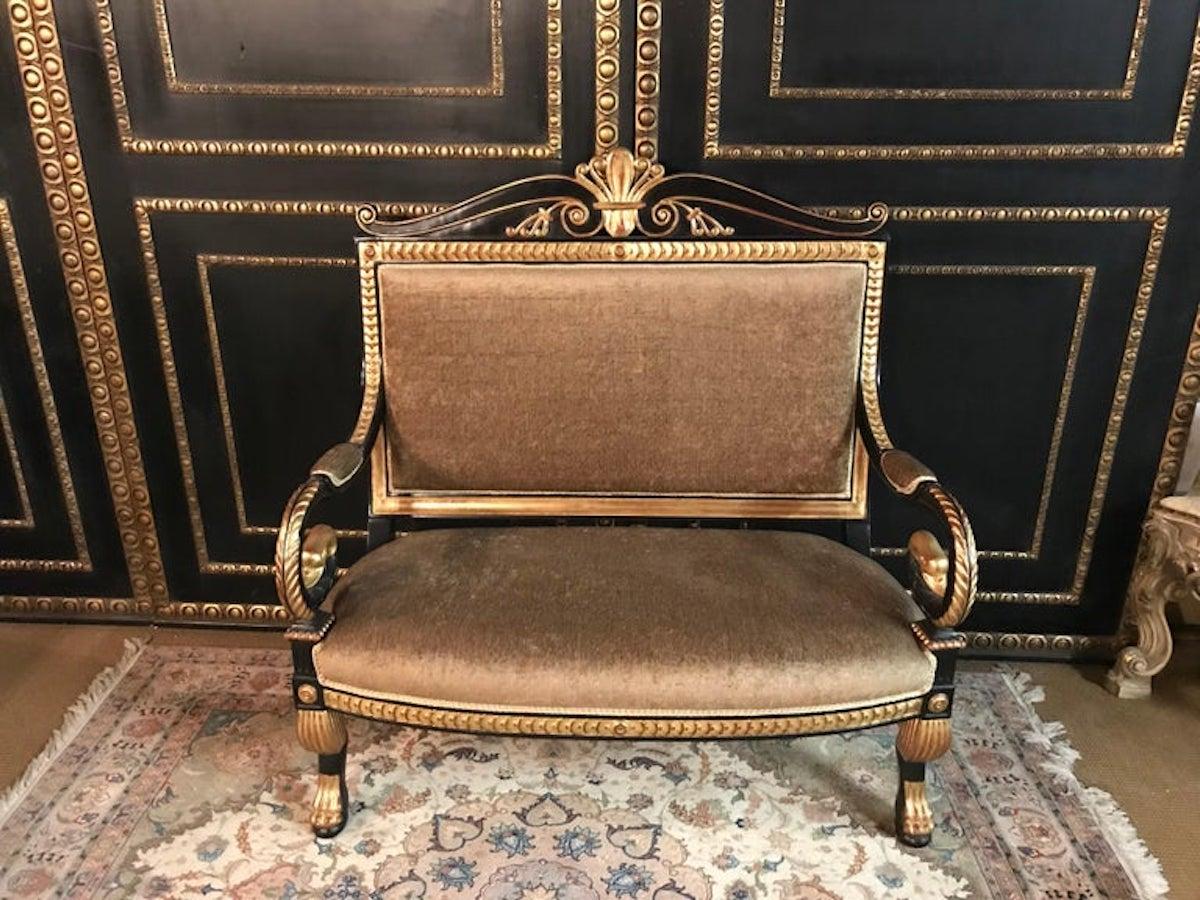 Very exact fine-carved sculpture made of solid, blackened beechwood. Poliment gold-plated. Scratched frame on sculpturally carved legs ending in claws. Armrests volute-shaped bent in swan head. High-right backrest frame crowned with classic volute