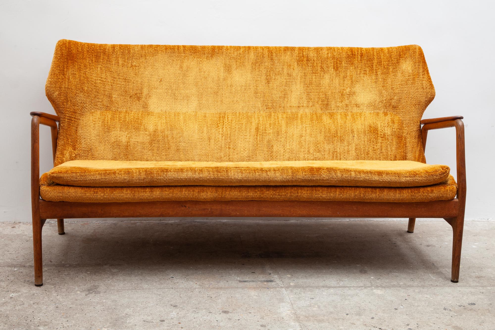 Early rare midcentury livingroom set composed of one lady-chair, one highback reading chair, attached neck pillow, and one sofa.
Beautifully sculpted teak frame and original amber-orange bouclé reupholstered. Timeless Danish style design.

Sofa: