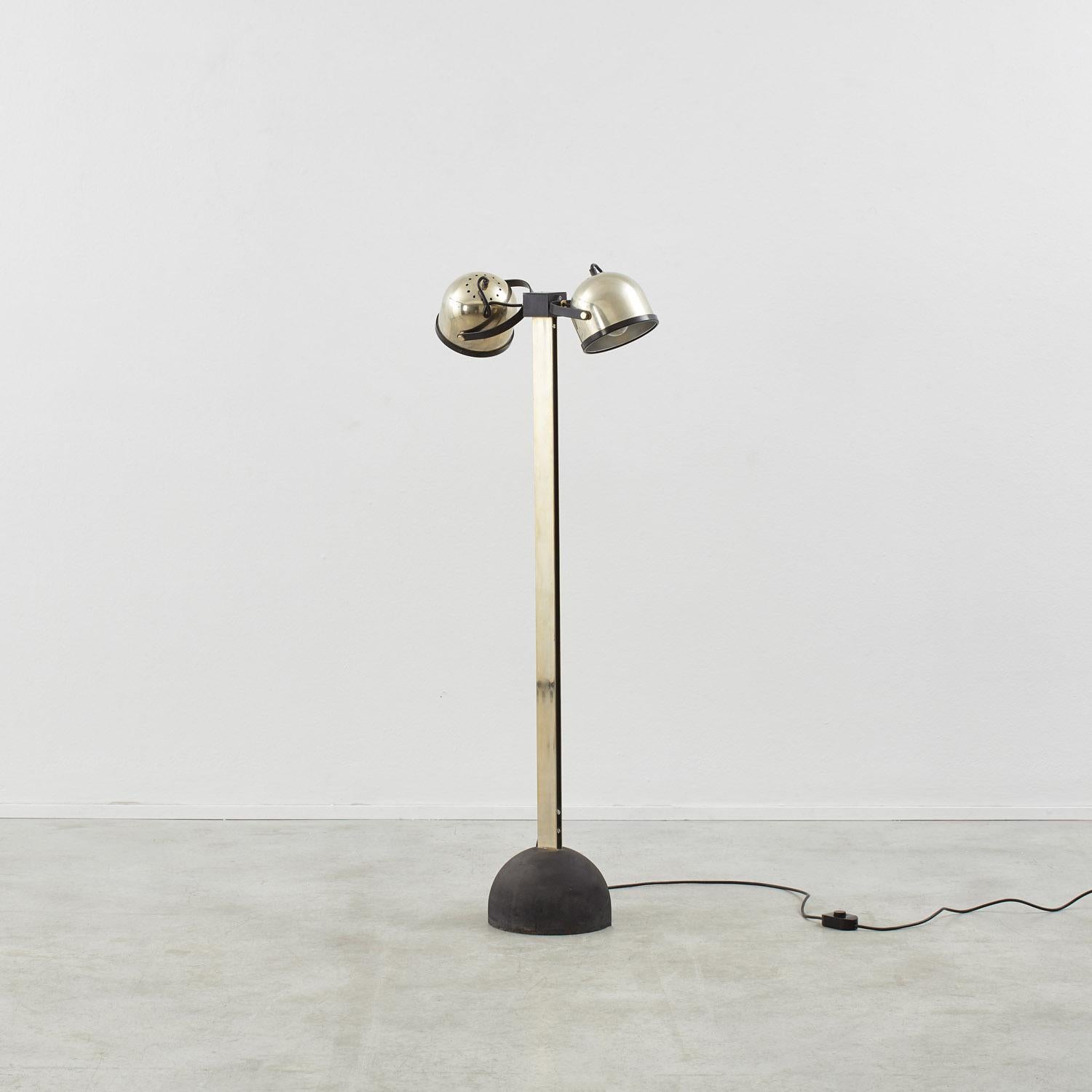 This rare floor lamp was the result of a formidable partnership between Italian designers Gae Aulenti and Livio Castiglioni, who shared an instinct for graphic, Bauhaus-informed silhouettes. Several editions were produced, including this dual-headed