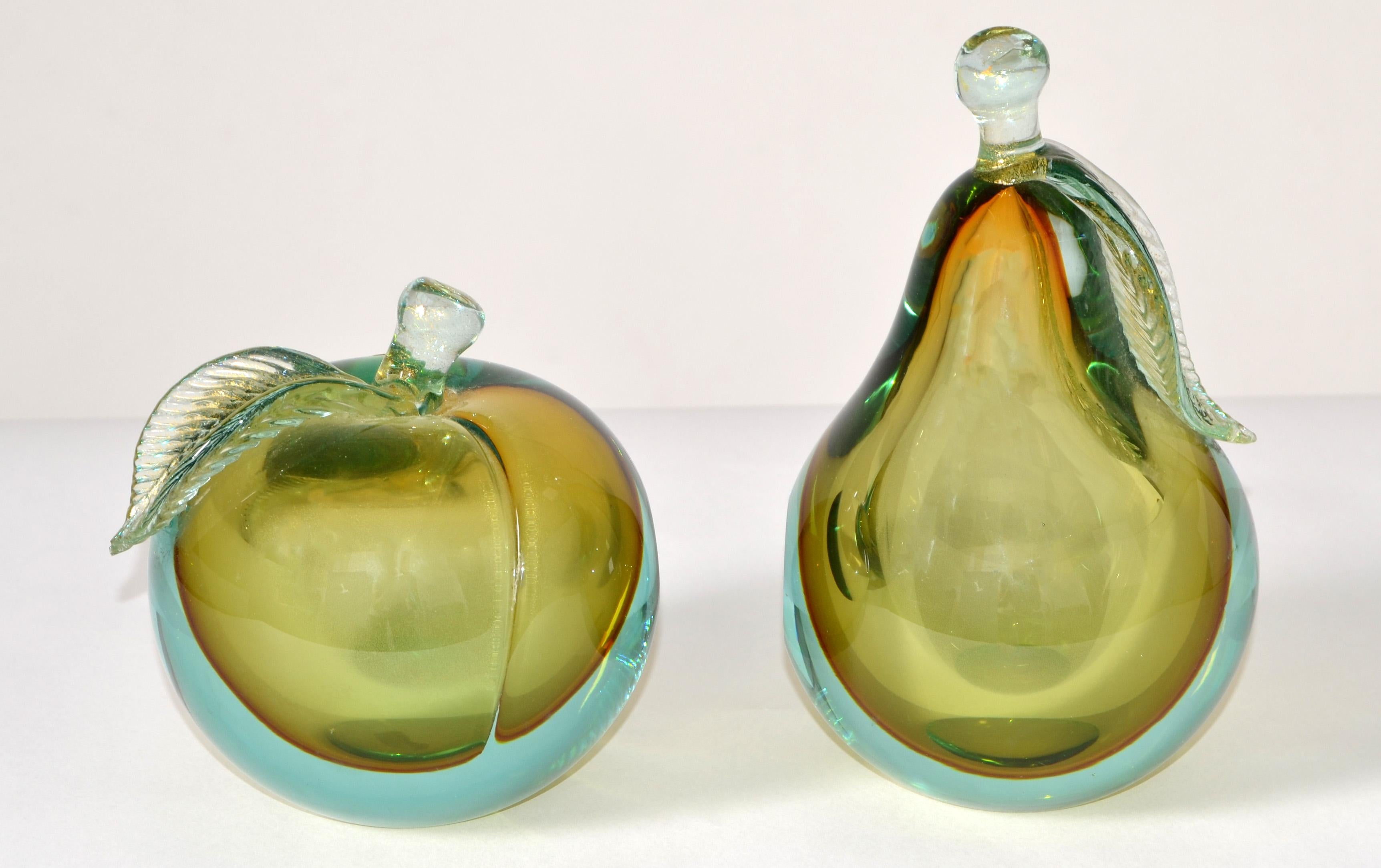 Genuine Venetian Murano Art Glass Apple and Pear Figurine, Sculptures or Bookends.
Heavy gold-filled glass with gold speckled leaves and stem each with a polished side and bottom. 
Unreadable Original Gold Label at the Apple and Parts of Blue