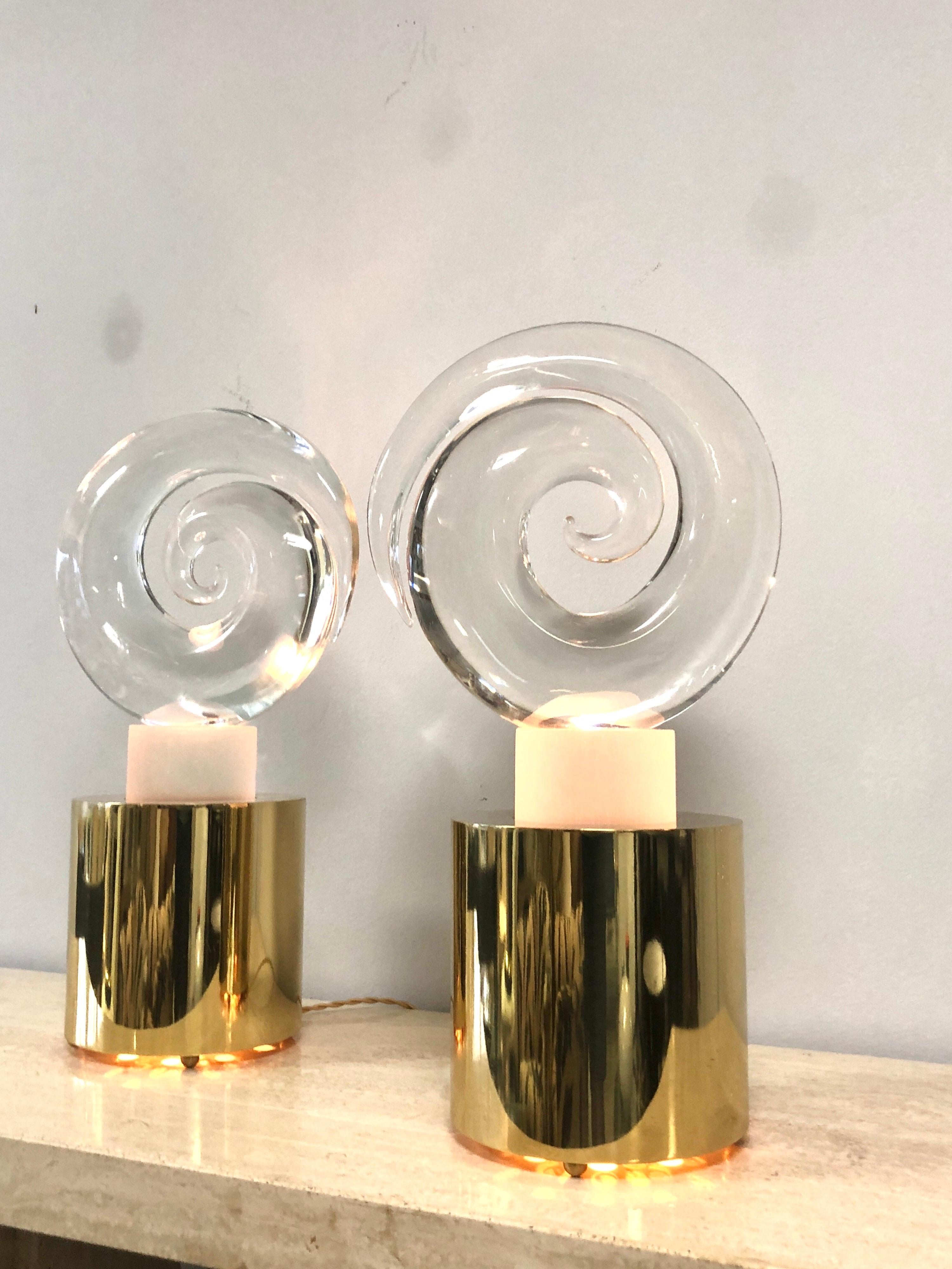 A rare pair of large sculptural lamps by extraordinary glass artist Livio Seguso. The solid art glass pieces rest on custom lighted metal bases. Quite unique. The glass is clear, there are removable pink and blue filters included. Both glass pieces
