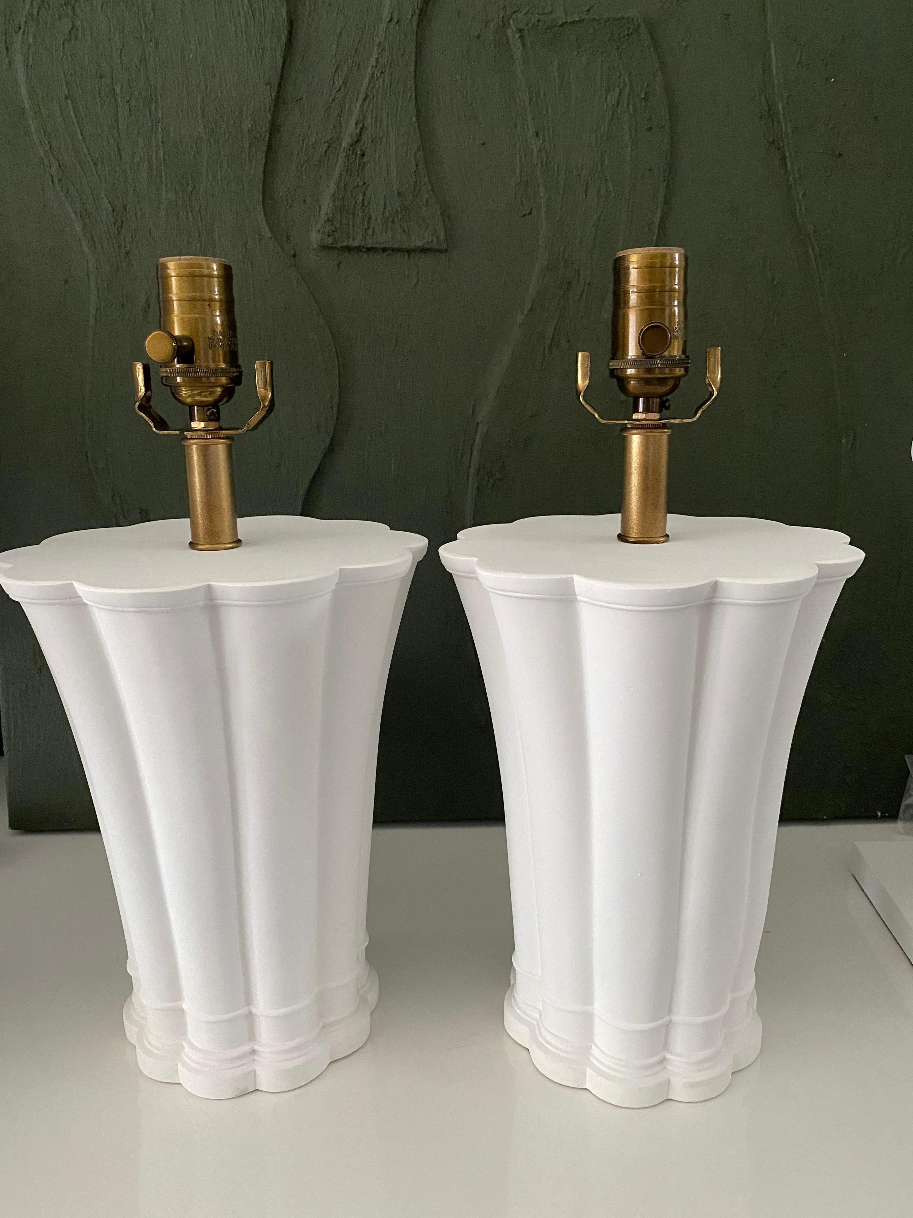 Hand made with care in Houston, Texas. This pair of plaster lamps features a lovely scallop silhouette, as well as antique brass socket and linen-wrapped cord.