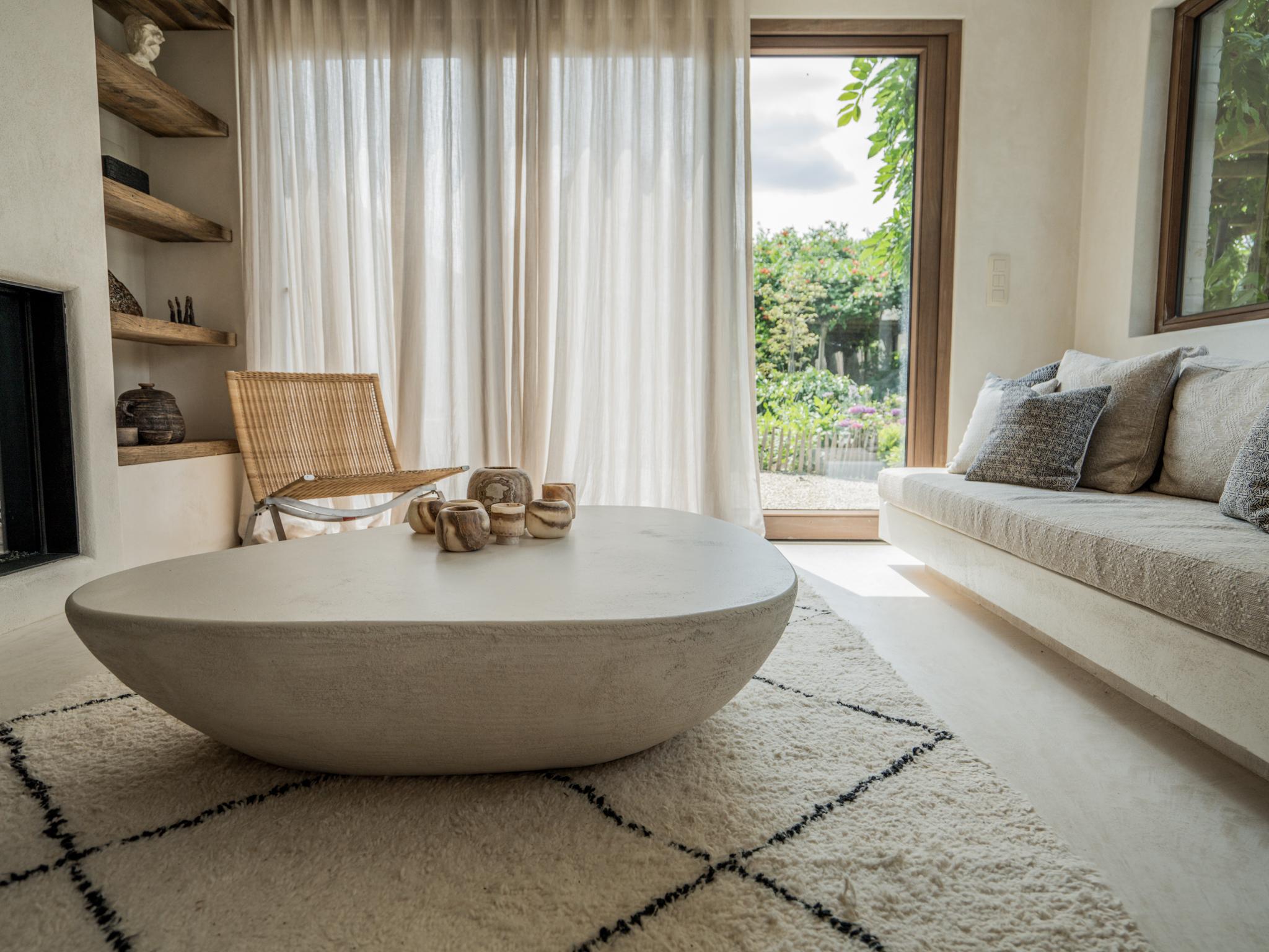 This unique coffee table named Tomelle is an inspiration of the boulders found in a river. When a boulder is cut in half, you get the form of this coffee table. To get a nice contrast between the cut surface and the outside of the boulder we added