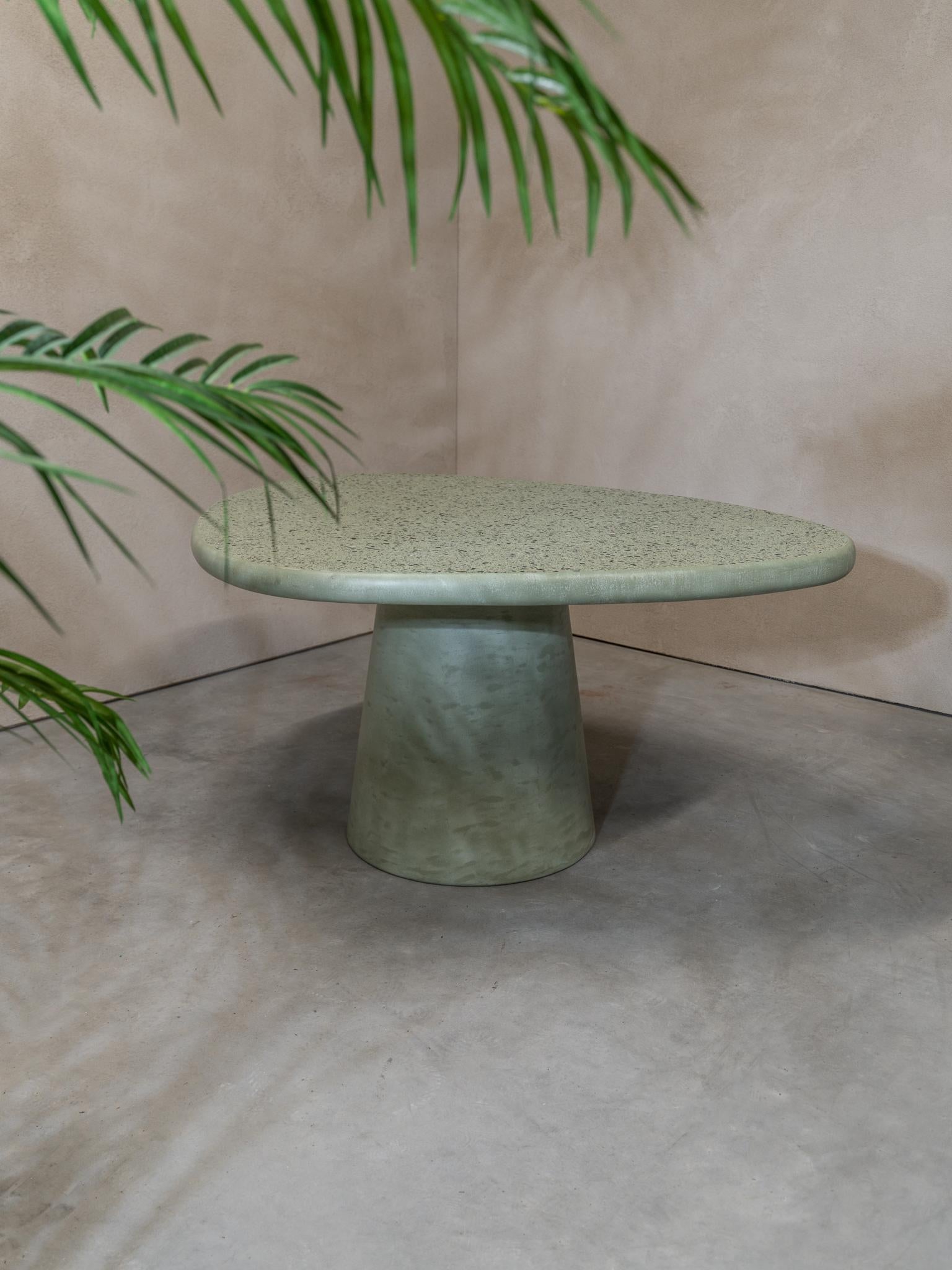 Liz Tables presents this beautiful green terrazzo table in a special shape. The often use this shape because it gives a certain stylish tension in the room. There is one soft corner'ish side on the table and one pointy side. When you are dining with