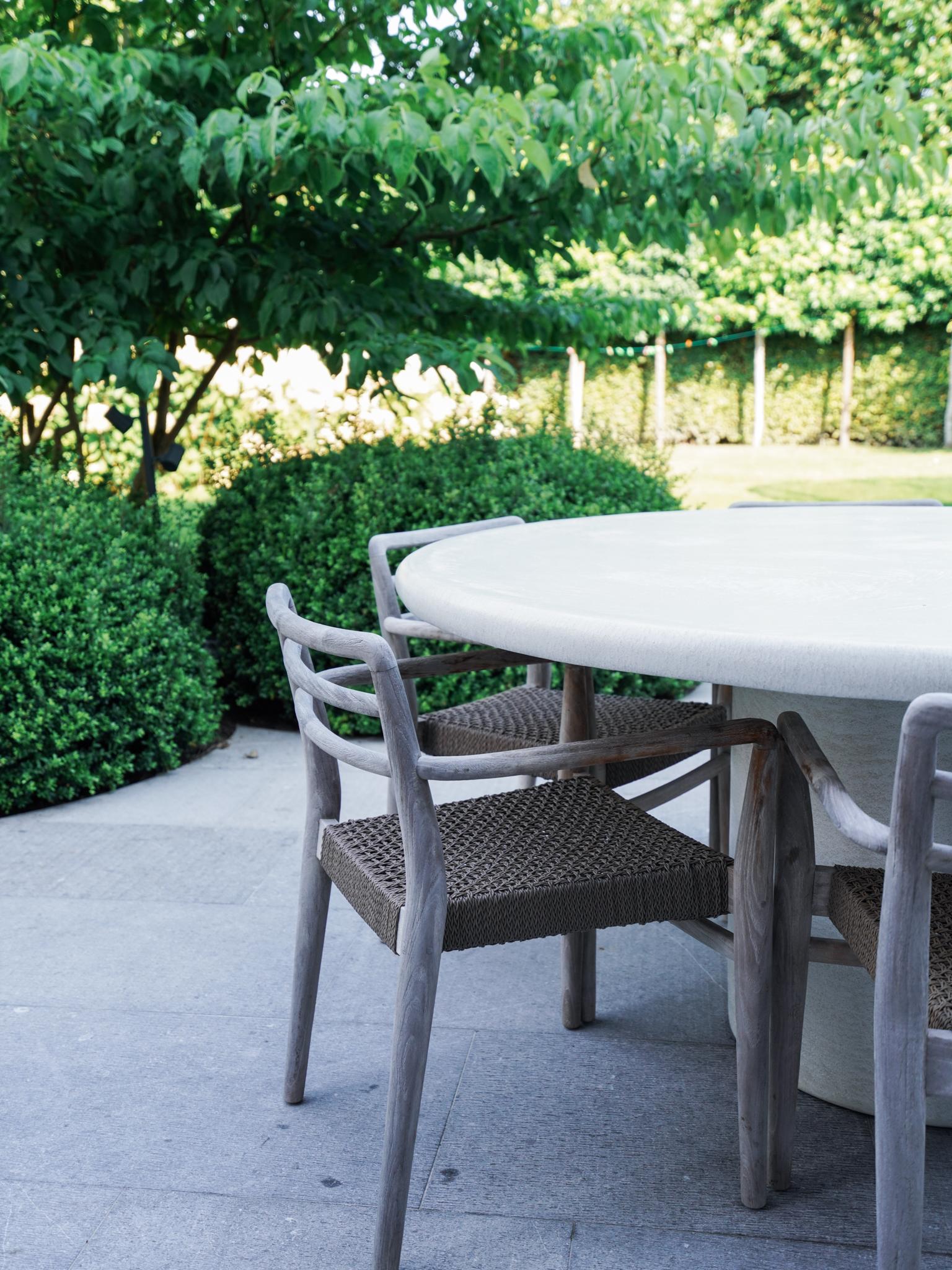 This table is made out of microcement, but especially for outdoors. The outdoor microcement is a special mixture of polymers, cement and silicate stones to make a very strong and durable surface with sublime looks. It's also a joy to sit on because