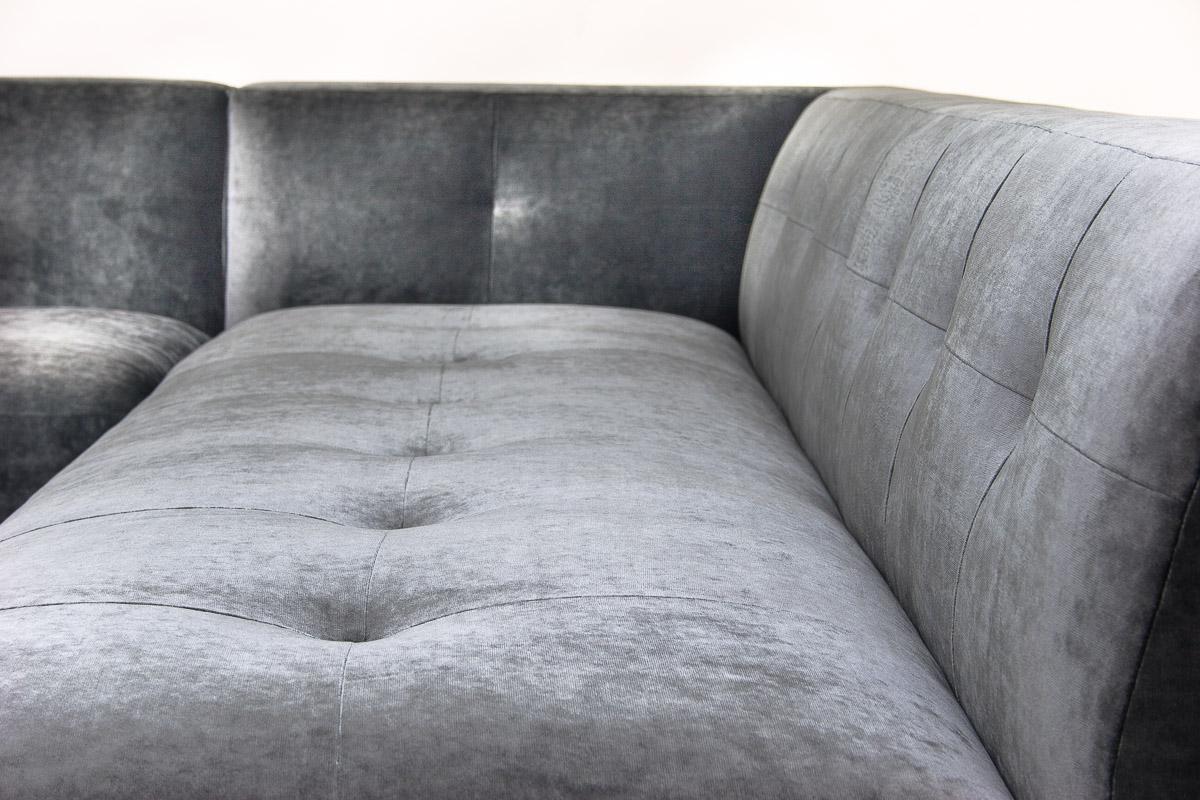This sleek minimal L-shape sectional is the perfect combination of glossy lacquer and rich textured fabric. The Lizo Sectional strikes just the right balance between minimalism and comfort, adding sophisticated style to your space. Two integrated