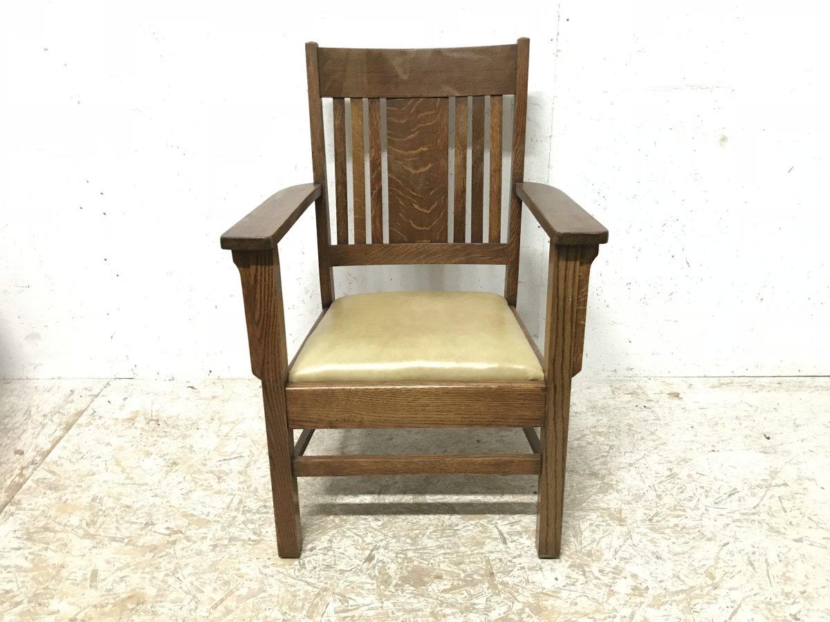 L&J Stickley Arts & Crafts oak armchair with curved back and shaped arm supports.
A professionally upholstered quality leather seat.

