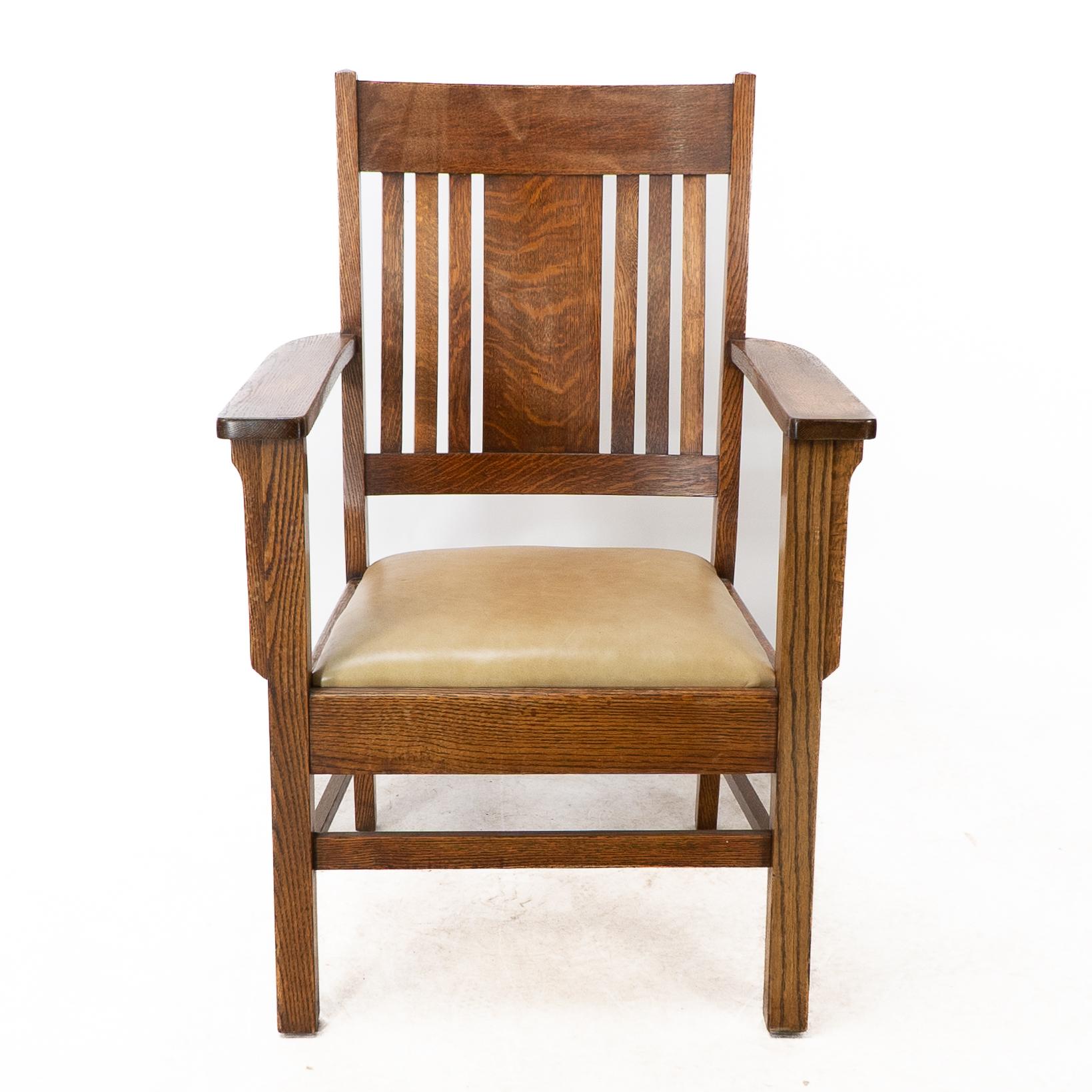 L&J Stickley Arts & Crafts oak armchair with curved back and shaped arm supports.
A professionally upholstered quality leather seat.

