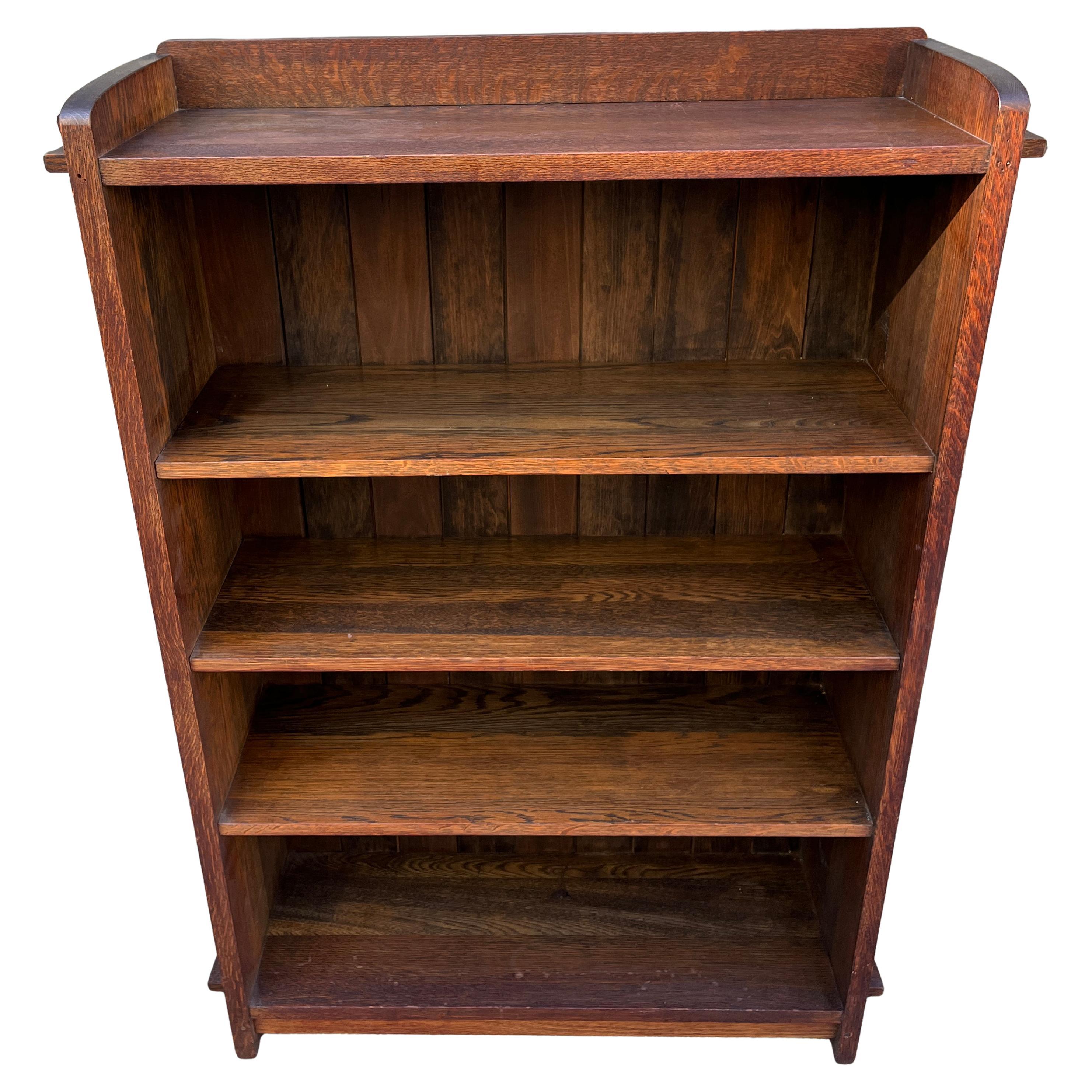 L&JG Stickley open bookcase with chamfered board back and tenon & key construction c1906-1912.  Stickley is a furniture brand that offers both Arts and Crafts and Mission-style furniture. Gustav Stickley, a major proponent of the Arts and Crafts