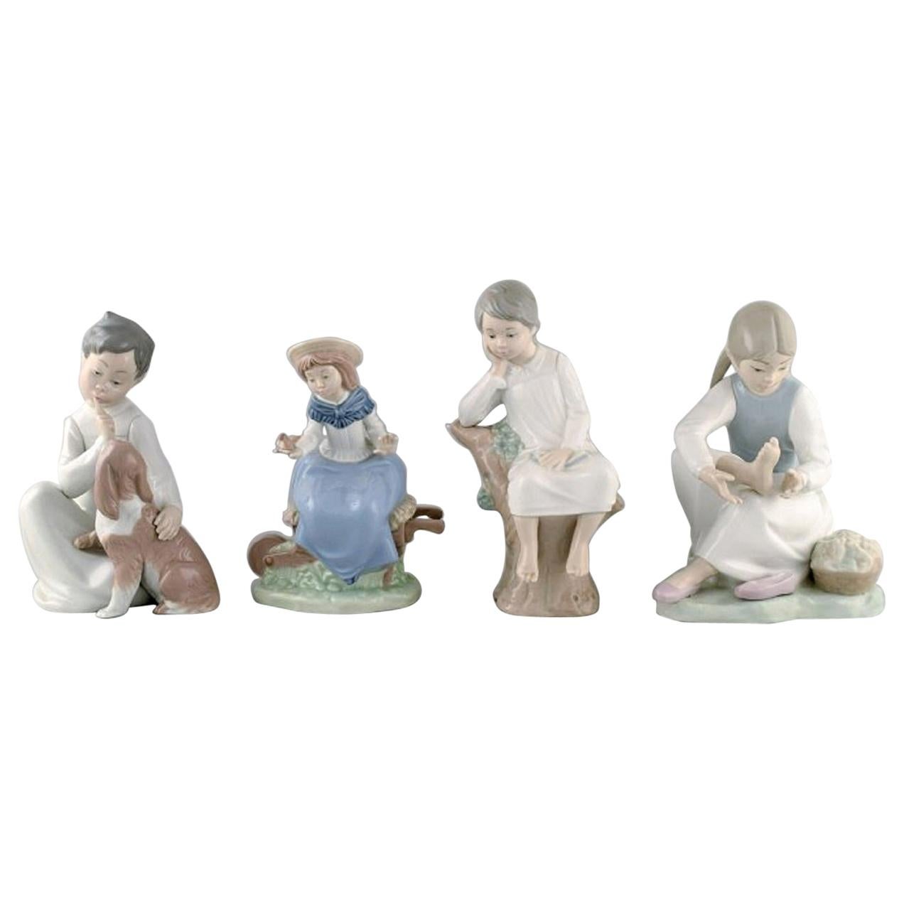 Lladro und Nao, Spanien, vier Porzellanfiguren von Kindern, 1980er-1990er Jahre