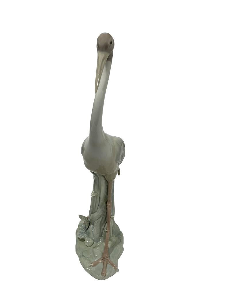 Lladro Porcelain Crane, 1970s

A Lladro, Spanish, porcelain high glazed pastel colored crane of 46.5 cm high, 21 cm wide and the depth 12 cm. The weight is 1690 grams. The original Lladro porcelain was made by three brothers; Juan, José and Vicente
