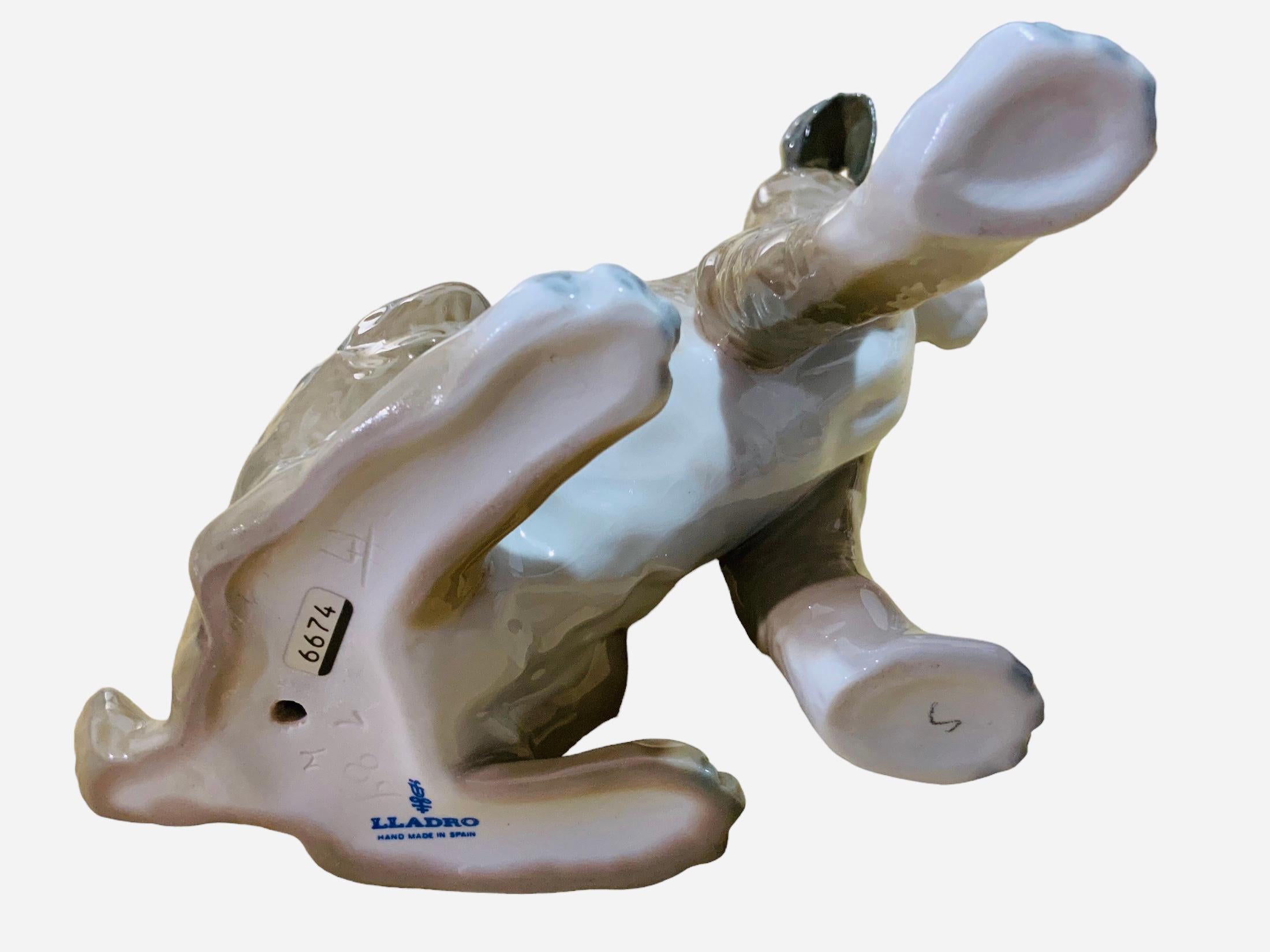 This is a Lladro porcelain figurine of a dog by Fulgencio Garcia. It depicts a hand painted full of details tall Setter standing up with a very expressive gaze. The Lladro hallmark  is below the figurine.