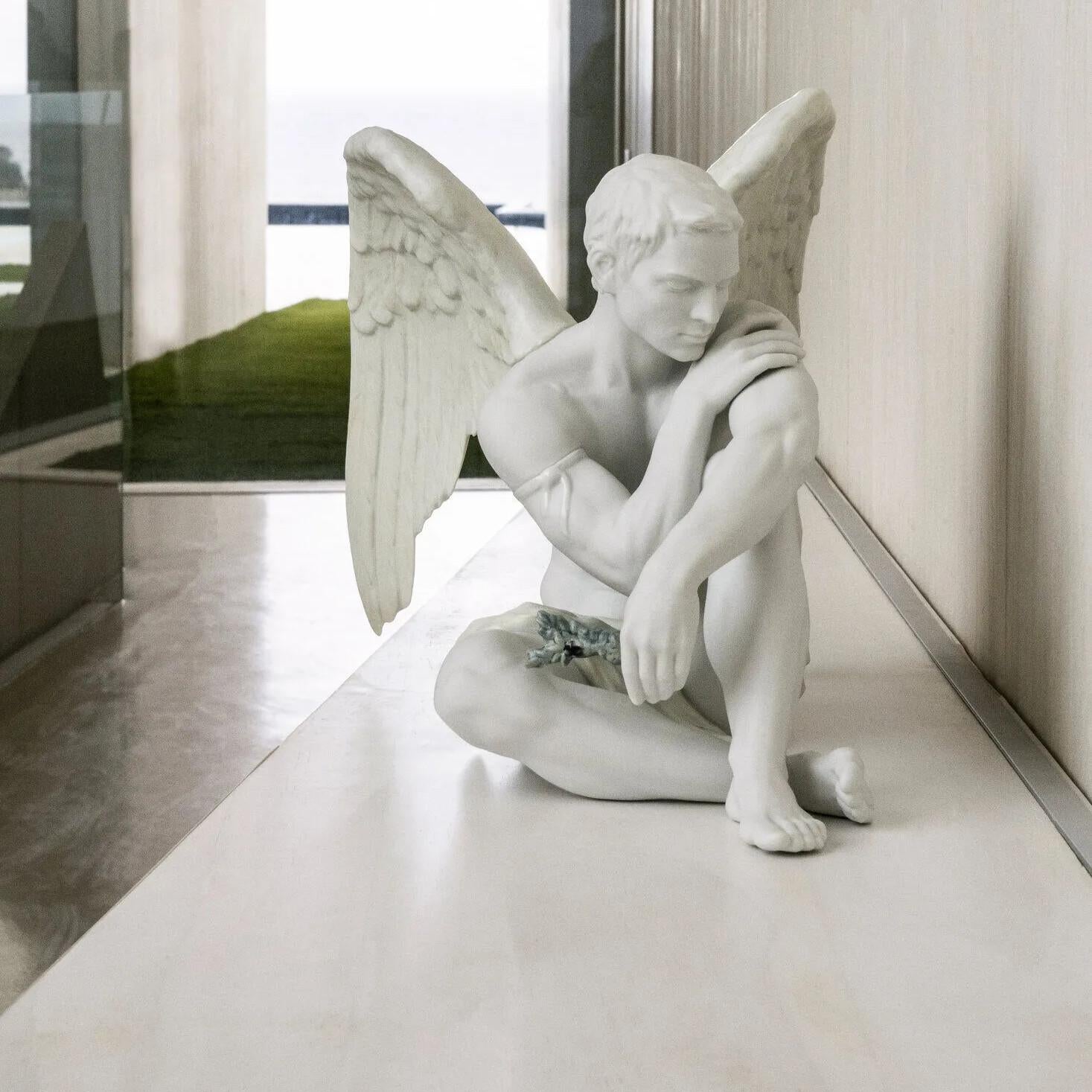 Absolutely STUNNING, white porcelain male angel figurine with an olive branch in one hand and decorated with softly colored shadows. A masculine figure, poised and powerful but calm. This angel who carries an olive branch in his hand is a