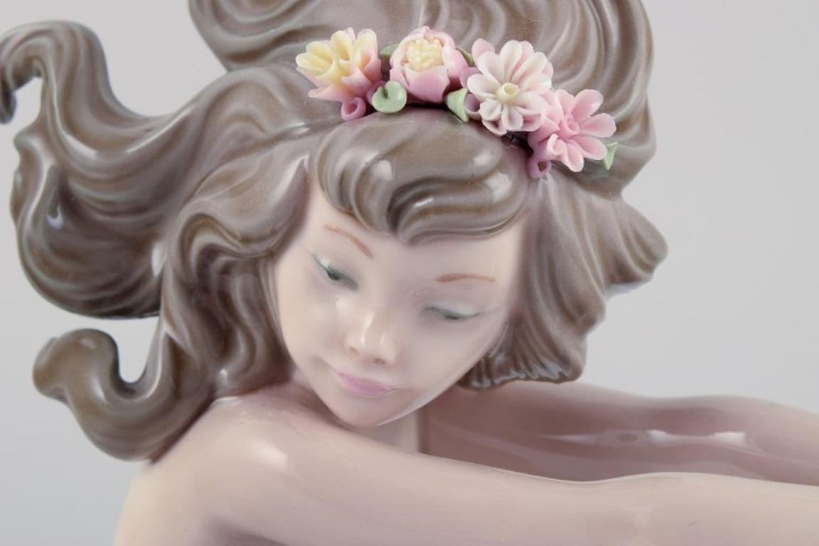 Spanish Lladro, Spain, handmade porcelain figurine of a sitting mermaid.