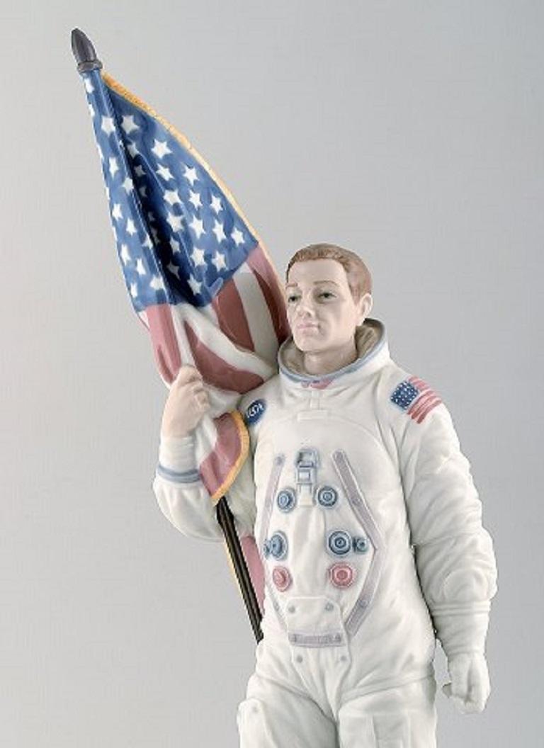 Lladro, Spain. Large rare figure in glazed porcelain.
American astronaut Neil Armstrong in spacesuit holding a flag.
