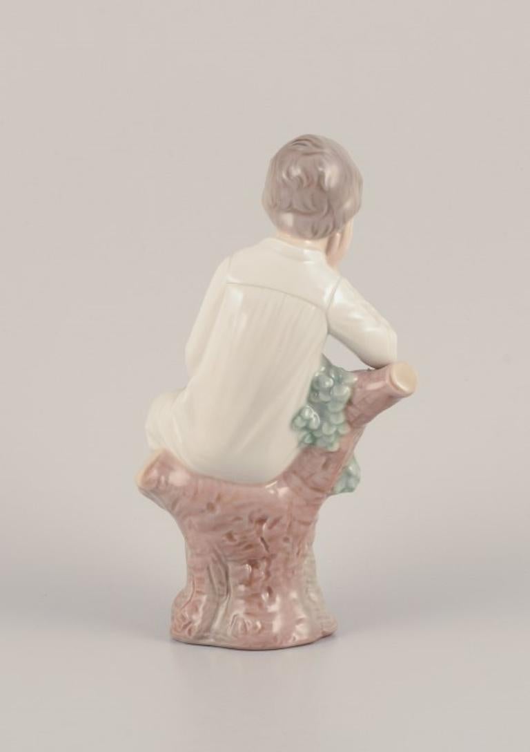 Glazed Lladro, Spain. Porcelain figurine of a girl sitting on a tree stump.  For Sale