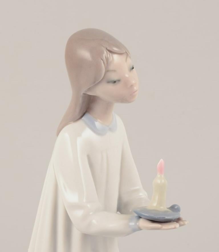 Spanish Lladro, Spain. Two porcelain figurines. Girl with a lamp and an angel with child For Sale