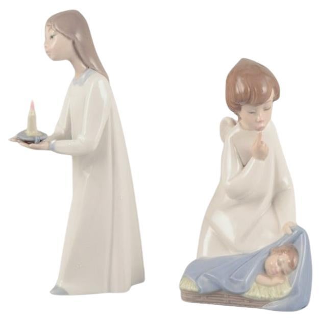 Lladro, Spain. Two porcelain figurines. Girl with a lamp and an angel with child For Sale