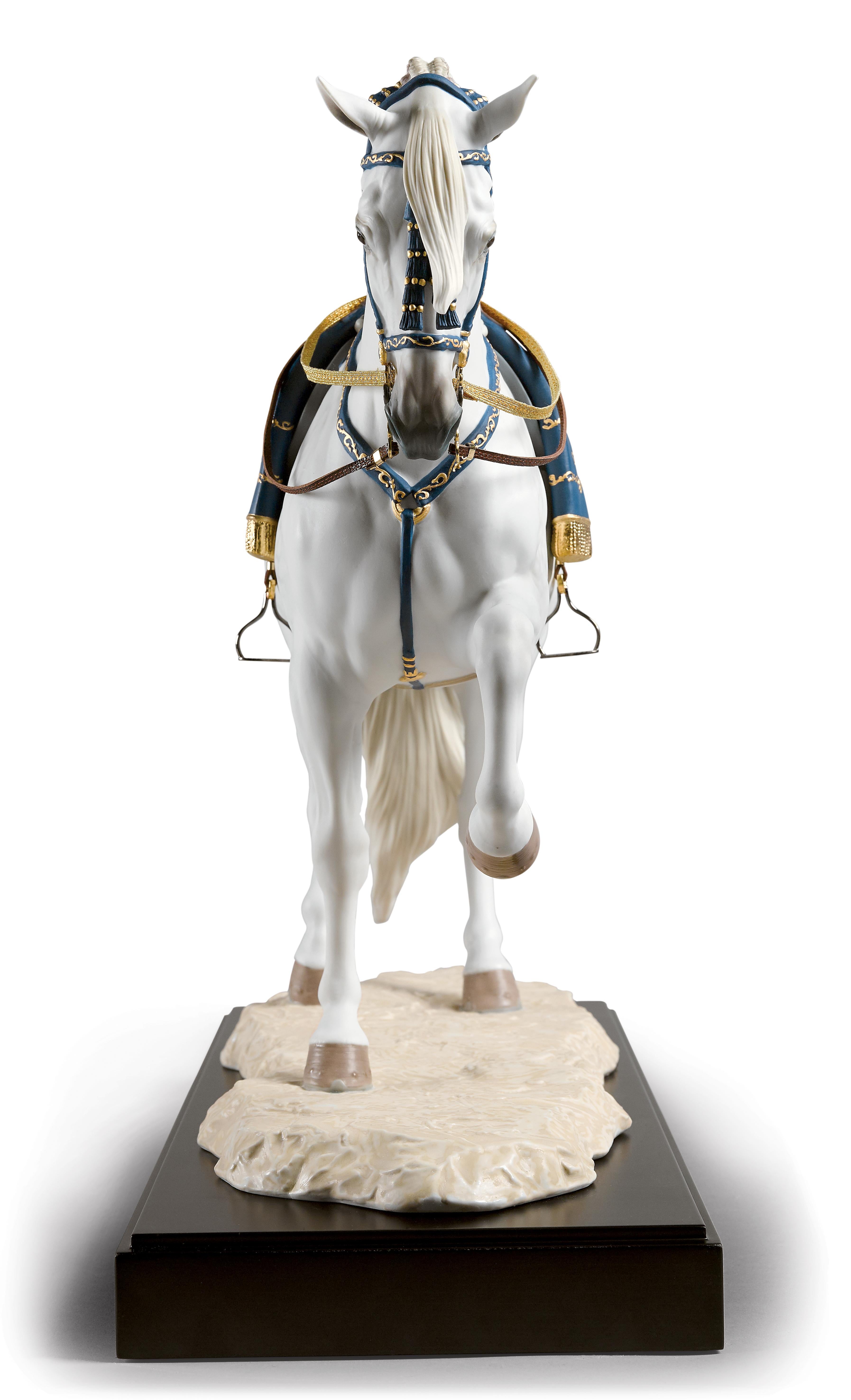 Sculpture en édition limitée d'un cheval espagnol au trot en position, en porcelaine mate, rehaussée de lustre bleu et or sur la tête, le poitrail, la selle et la couverture. Fidèlement inspiré des exemples de l'École royale andalouse d'art
