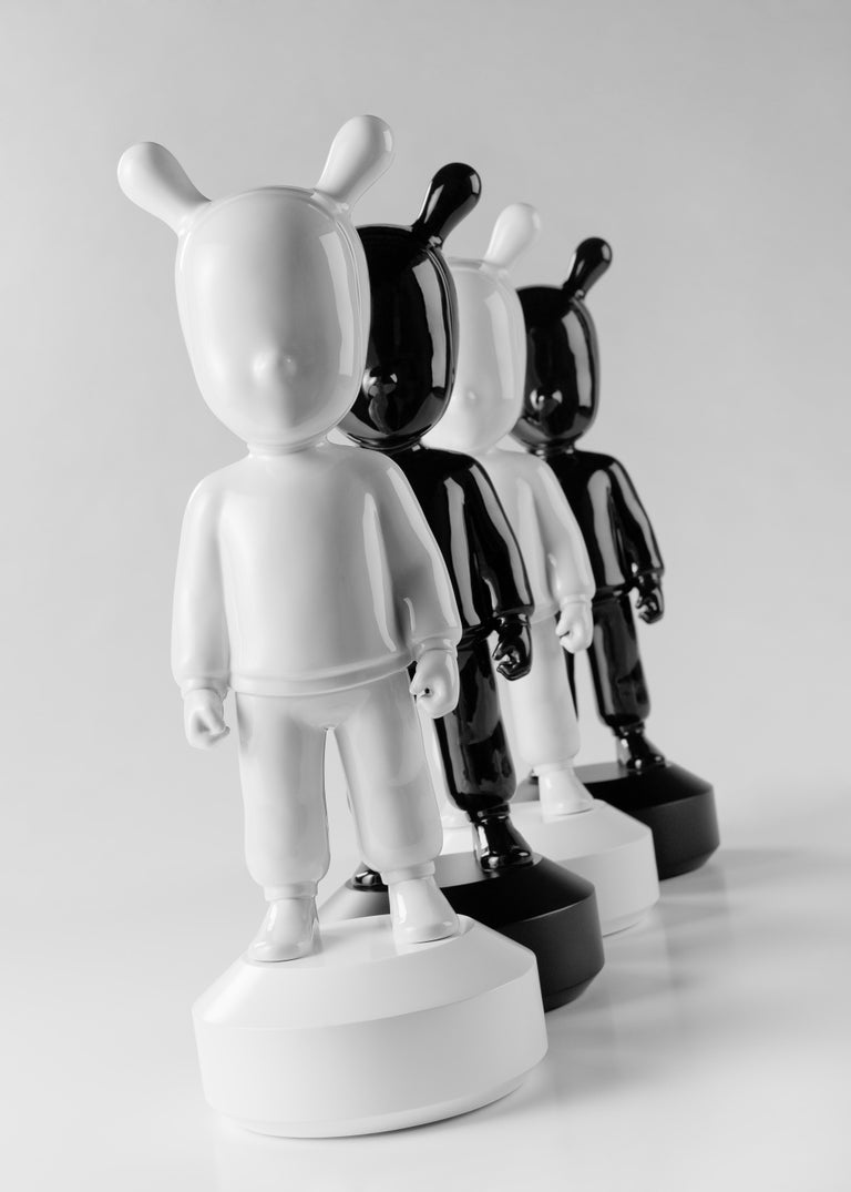 Black porcelain figurine created by Jaime Hayon for the collection The Guest by LLadró Atelier with a black base attached to the piece. The Guest is a piece created by Jaime Hayon for The Guest collection by Lladró Atelier, the brand's ideas lab,