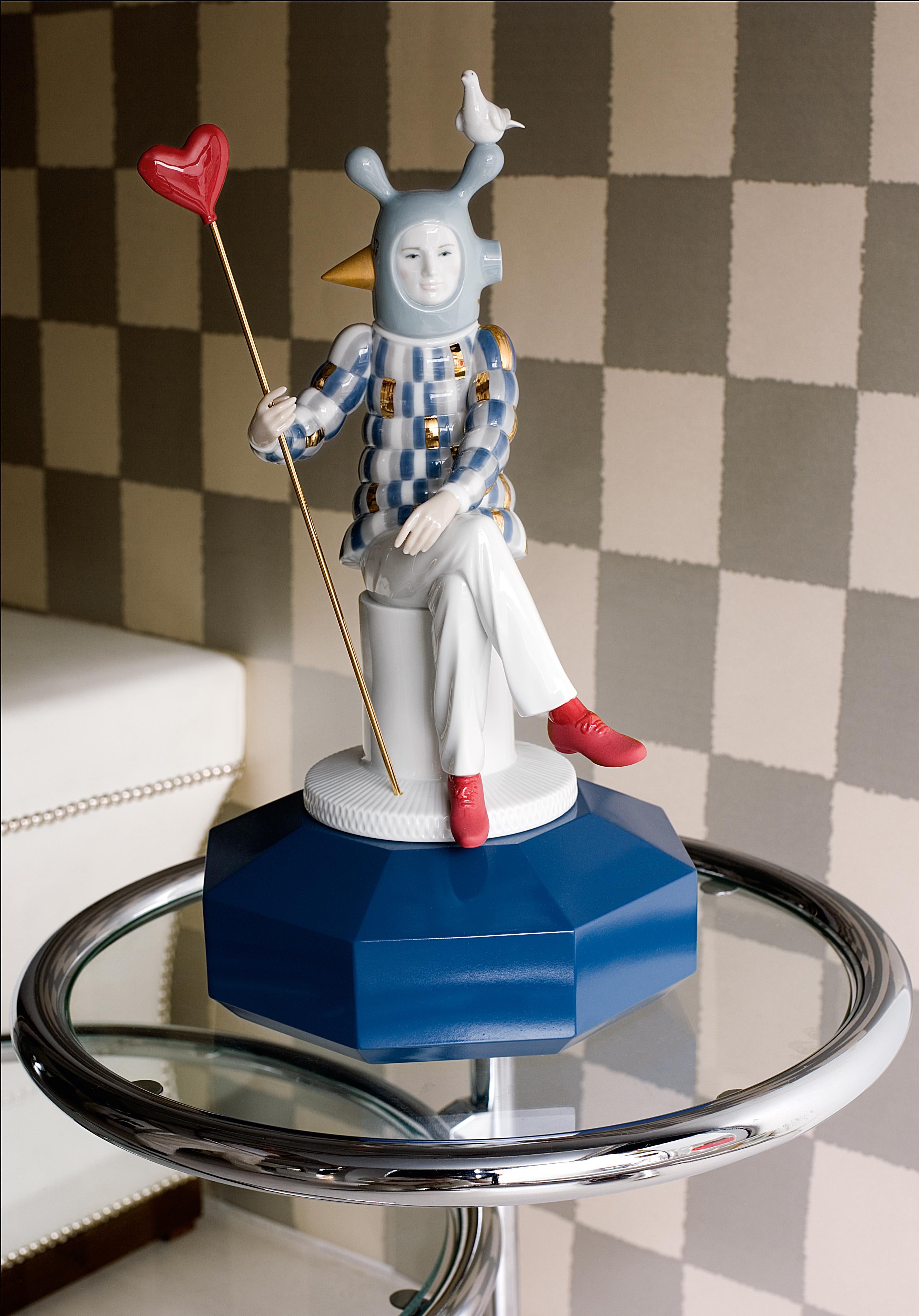 Glossy porcelain figurine designed by Jaime Hayon with modern design and touches of gilded sheen highlighting the red heart and shoes and blue pedestal. Like all the pieces in Jaime Hayon's The Fantasy collection, this creation arises from the